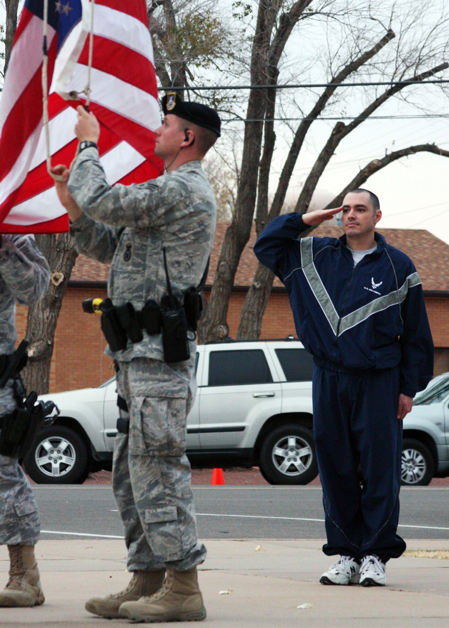 CANNON AIR FORCE BASE, N.M. --Tech. Sgt. Joseph Martin, 27th Special Operations Communications Squadron, salutes as the flag is lowered for the night. With the new PTU/IPTU uniform regulations, all military customs and courtesies honoring the flag during reveille and retreat still apply (U.S. Air Force photo by Airman 1st Class Jette Warnick)