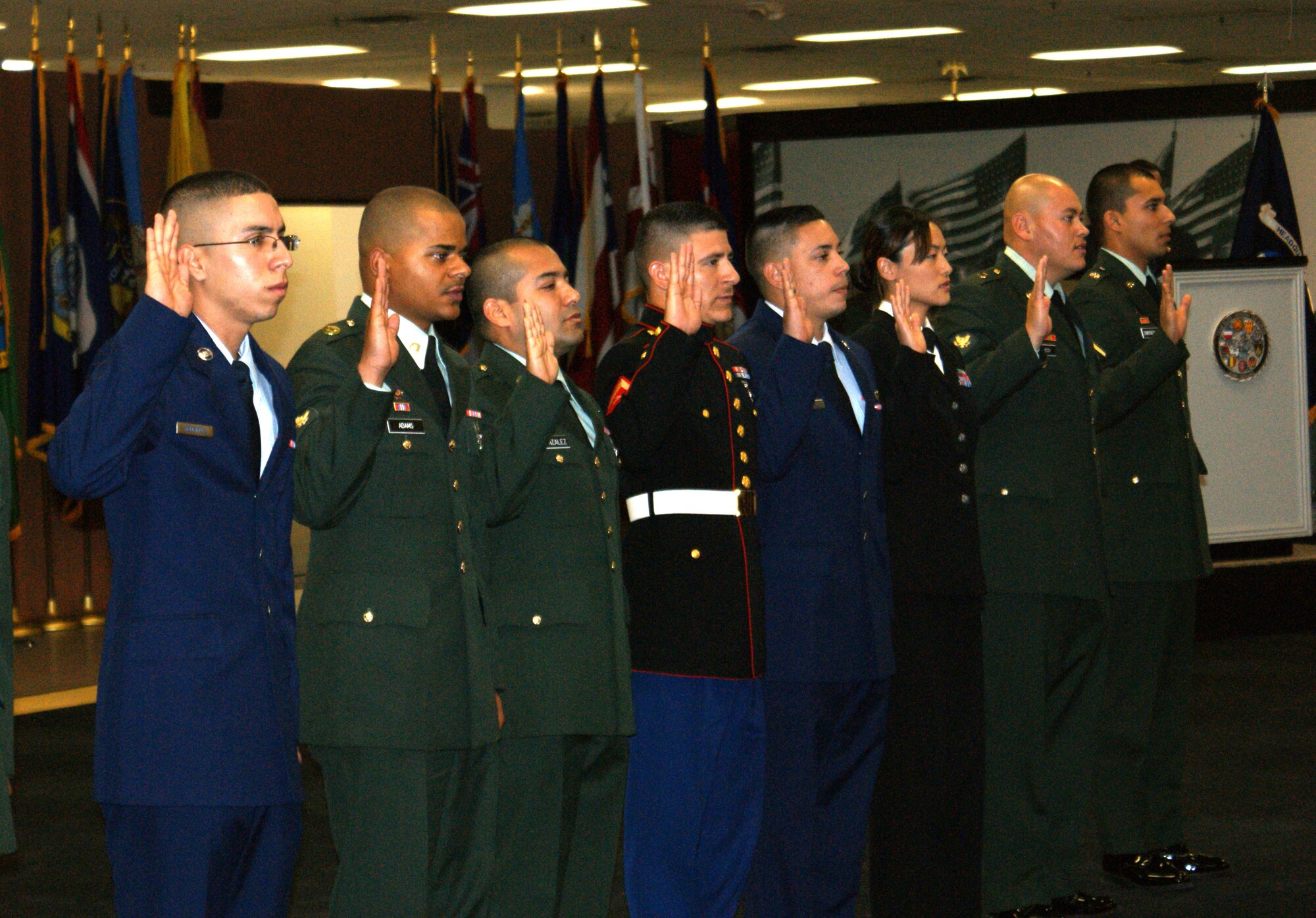 EL PASO, Texas -- Two Airmen from Holloman Air Force Base, N.M., Airman 1st Class Sergio Rodriguez, 49th Logistics Readiness Squadron, originally from Mexico, and Airman Andres Fossi, 49th Civil Engineer Squadron, a Colombia native, are given the Oath of Allegiance along with eight other servicemembers during a Veteran's Day ceremony here, Nov. 14. All of the servicemembers became U.S. citizens in front of more than 200 Vietnam veterans from the area. (Courtesy photo)