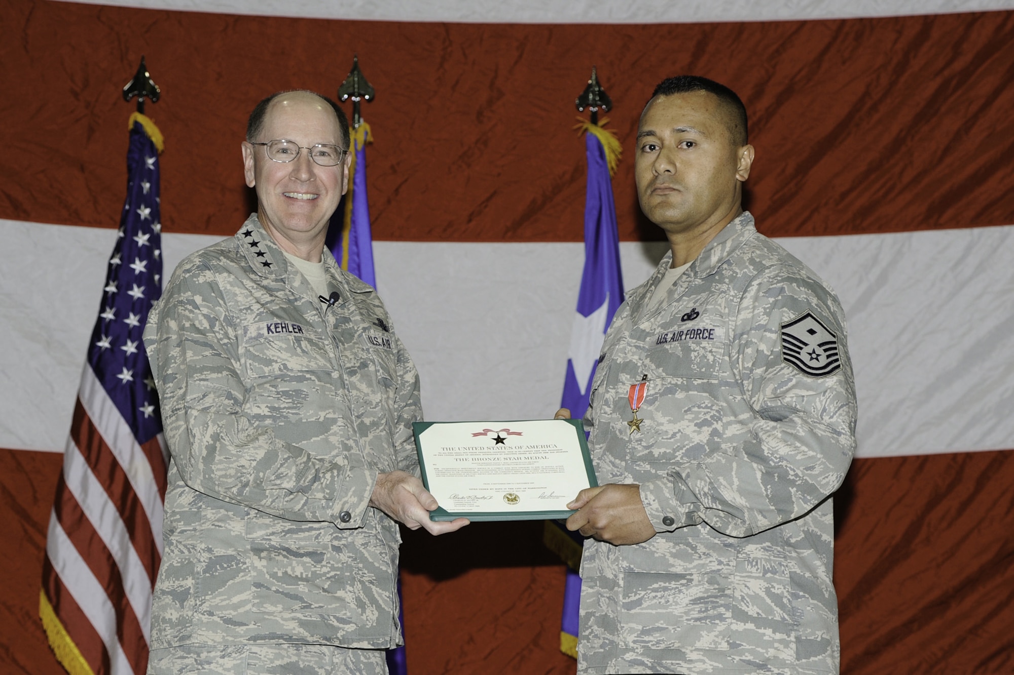 MALMSTROM AIR FORCE BASE, Mont. --Gen. C. Robert Kehler, Air Force Space Command commander, poses with Master Sgt. Fiafia Seau, 741st Missile Security Forces Squadron first sergeant, after presenting him with the Bronze Star medal Nov. 12 prior to the start of an all-call. The general was making a final appearance at the missile wing before the transition to Air Force Global Strike Command takes place Dec. 1. (U.S. Air Force photo/Beau Wade)