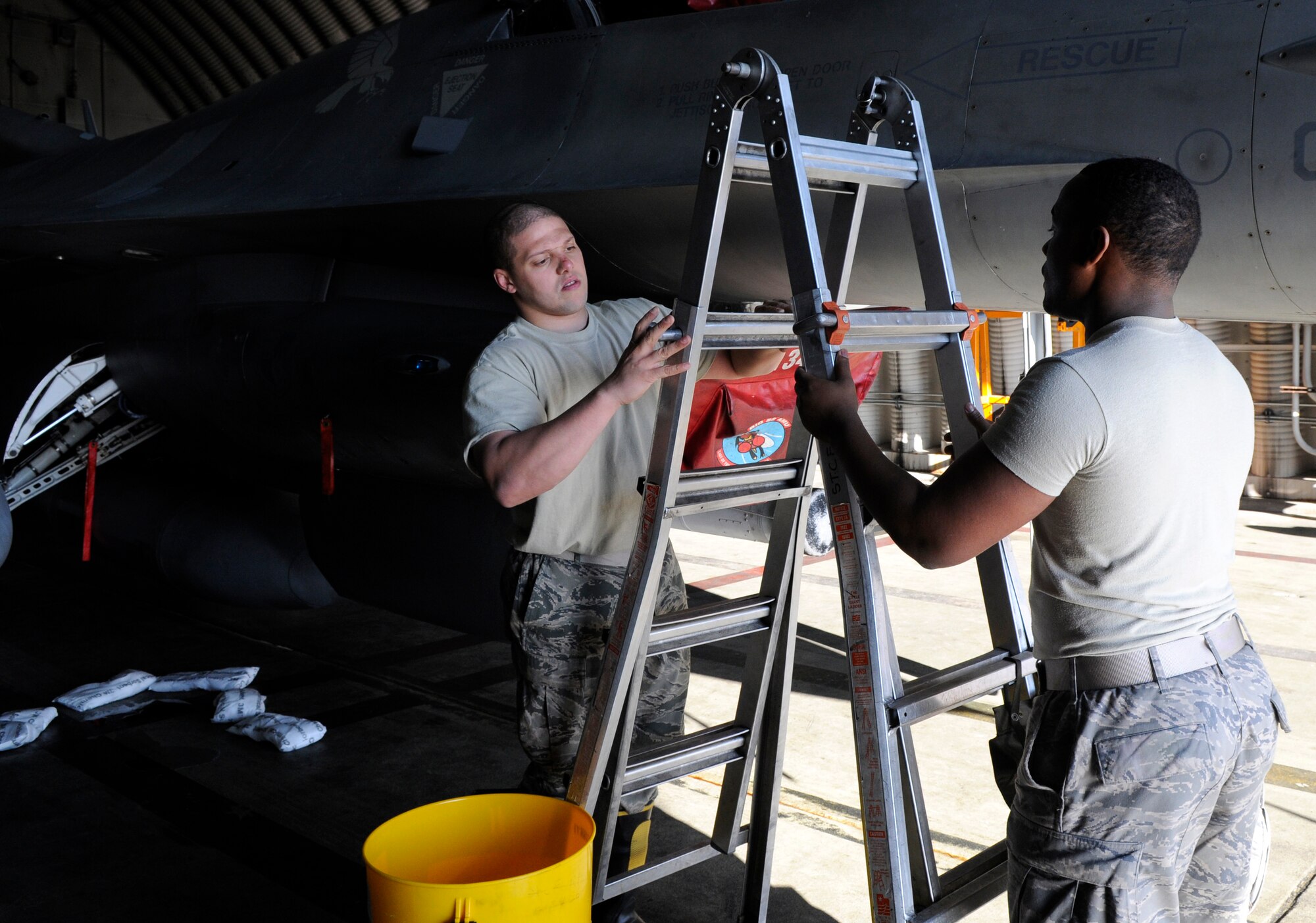 SPANGDAHLEM AIR BASE, Germany – Senior Airman Thamir Rimbert and Airman 1st Class Thadies Henderson, 52nd Component Maintenance Squadron, set up to contain a simulated hydrazine fuel spill during a hydrazine response exercise Nov 19. Hydrazine fuels the emergency power unit of an F-16 Fighting Falcon in the event the aircraft loses hydraulic, electrical or engine power in flight. (U.S. Air Force photo/Airman 1st Class Staci Miller)