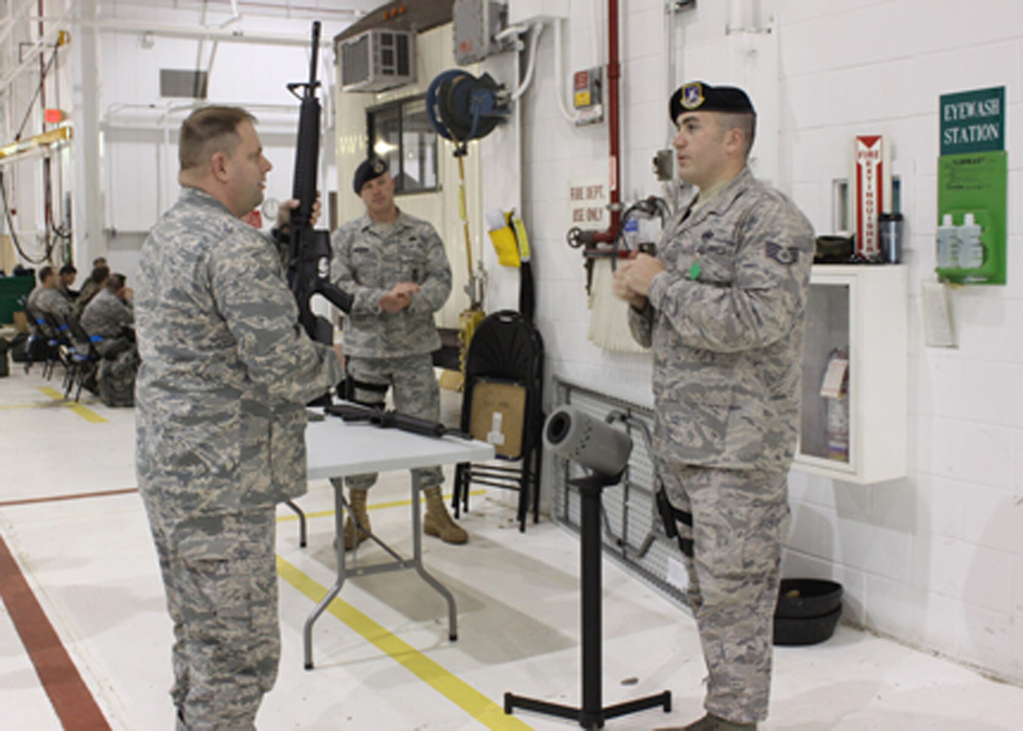 Staff Sgt. James Hindinger and Tech. Sgt. Michael Boehning, 911th Security Forces Squadron, explain weapons clearing barrel procedures to Maj. Todd McCrann, 911th Logistics Squadron commander, during operational readiness circuit training held here Nov. 7, 2009.  The hands-on training involved various stations geared to familiarize 911th Airlift Wing members with items being tested during the upcoming December inspection.