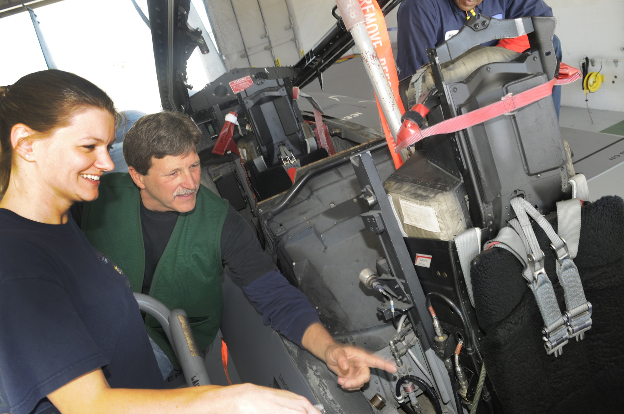 Melissa Barber, wife of MSgt. David Barber, 78th SFS, looks on as Bret Puckett, first line supervisor, shows her the inside an F-15 cockpit. U. S. Air Force photo by Sue Sapp