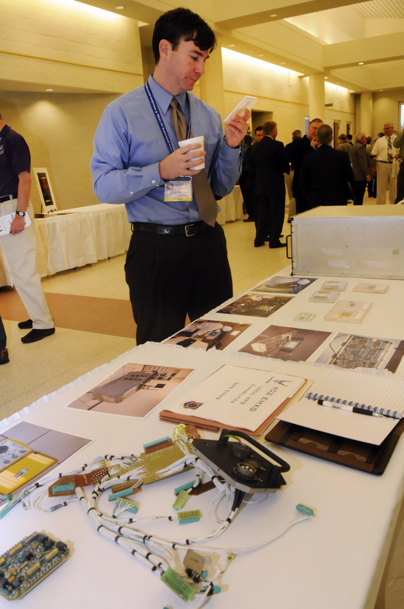 Brandon Wolfson, TSC Phase IV Systems Operation, from Huntsville, Ala. looks at a display of the 560th EMXS at the Requirements Symposium. U. S. Air Force photo by Sue Sapp  