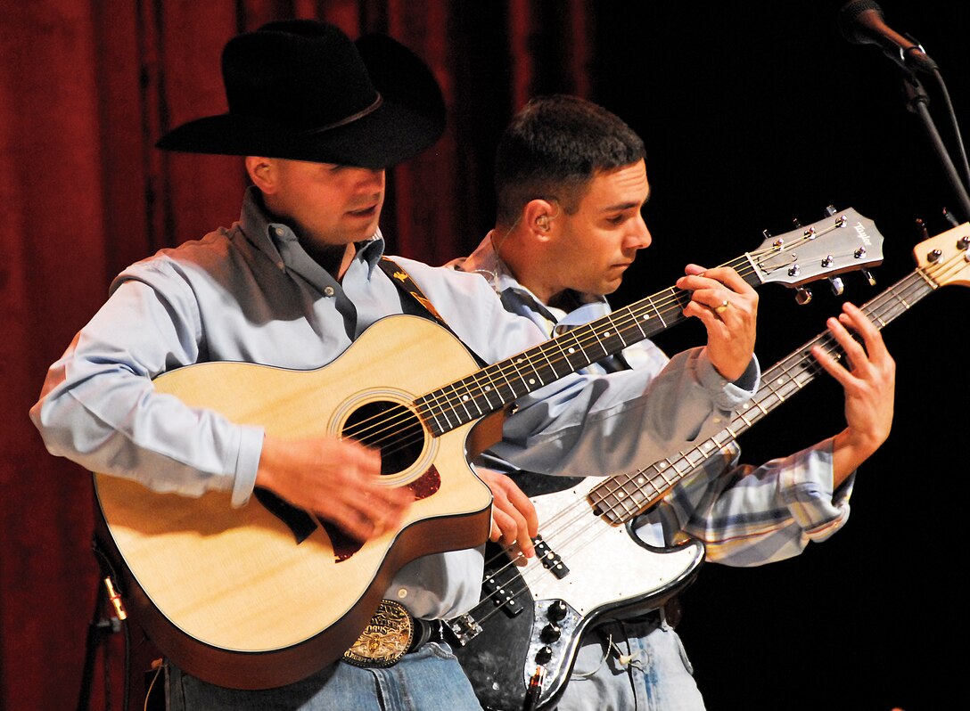 From left to right, Master Sgt. Jerome Oddo, the bass player for Wild Blue Country, and Tech. Sgt. Jeffrey Valentine, a steel guitar player for WBC, perform at the Memorial Auditorium Nov. 17 in Wichita Falls, Texas.  WBC is an Air Force Academy Band that performs all over the nation. (U.S. Air Force photo/ Harry Tonemah)