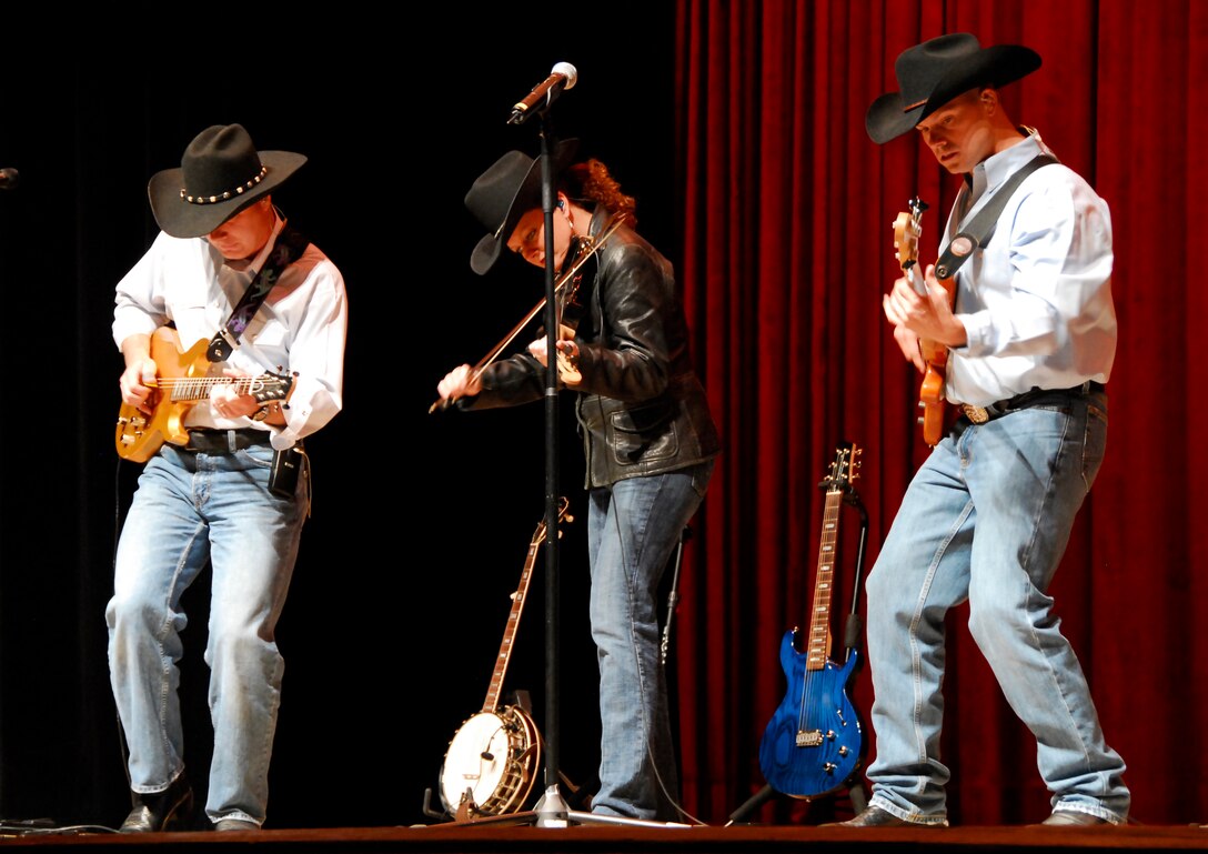 From left to right, Tech. Sgt. Stephen Brannen, a guitarist for Wild Blue Country, Tech. Sgt. Julie Bradley, the vocalist for WBC, and Master Sgt. Jerome Oddo, the bass player for WBC, perform at the Memorial Auditorium Nov. 17 in Wichita Falls, Texas.  WBC is an Air Force Academy Band that performs all over the nation. (U.S. Air Force photo/ Harry Tonemah)