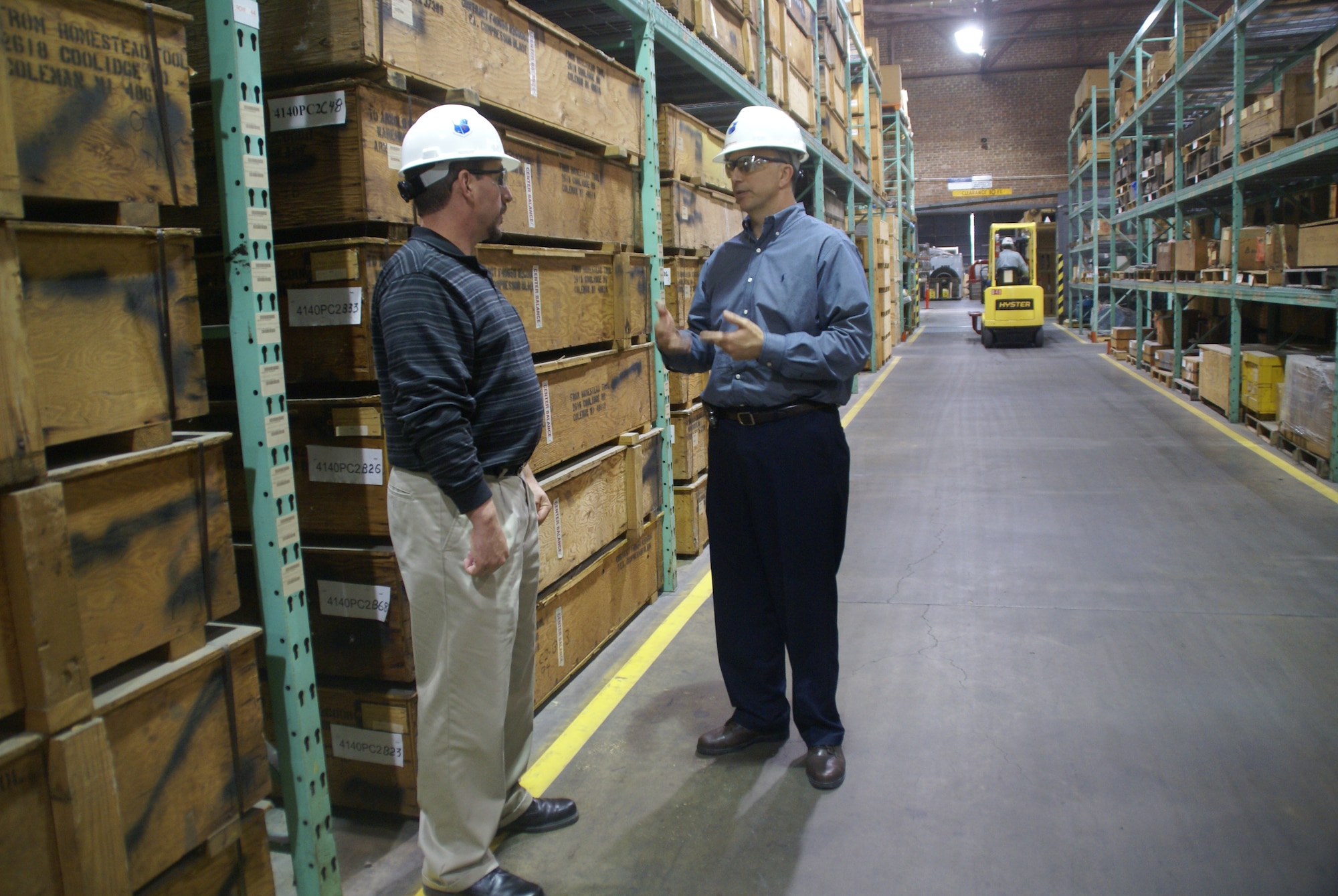 From left, Erik Wineland, Arnold Engineering Development Center’s (AEDC) supply technical advisor, confers with Mike Ramsey, Aerospace Testing Alliance’s logistics support branch manager, about best practices at the main warehouse during an informal inspection. Wineland performs quality assurance evaluation duties for the supply portion of the AEDC contract for logistics support. (Photo by Philip Lorenz III)