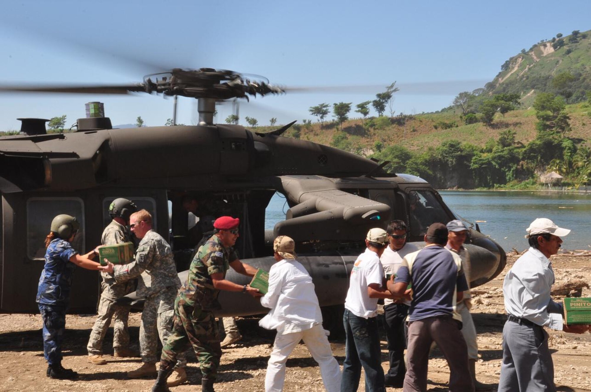 ILOPANGO, El Salvador - U.S. servicemembers, a Civil Affairs team, Salvadoran military and villagers from El Sauce help unload a UH-60 Blackhawk helicopter, assigned to Joint Task Force-Bravo, Nov. 17 near El Sauce, El Salvador. A Civil Affairs team from Special Operations Command South, based out of Homestead, Florida, provided vital aid to the small village of El Sauce by dropping off more than 5,000 total pounds of food and water Nov. 17 and 18. This has been a combined effort by Salvadoran government and military, the people of El Sauce, the U.S. Agency for International Development, or USAID, Civil Affairs and Joint Task Force-Bravo (U.S. Air Force photo/Staff Sgt. Chad Thompson).