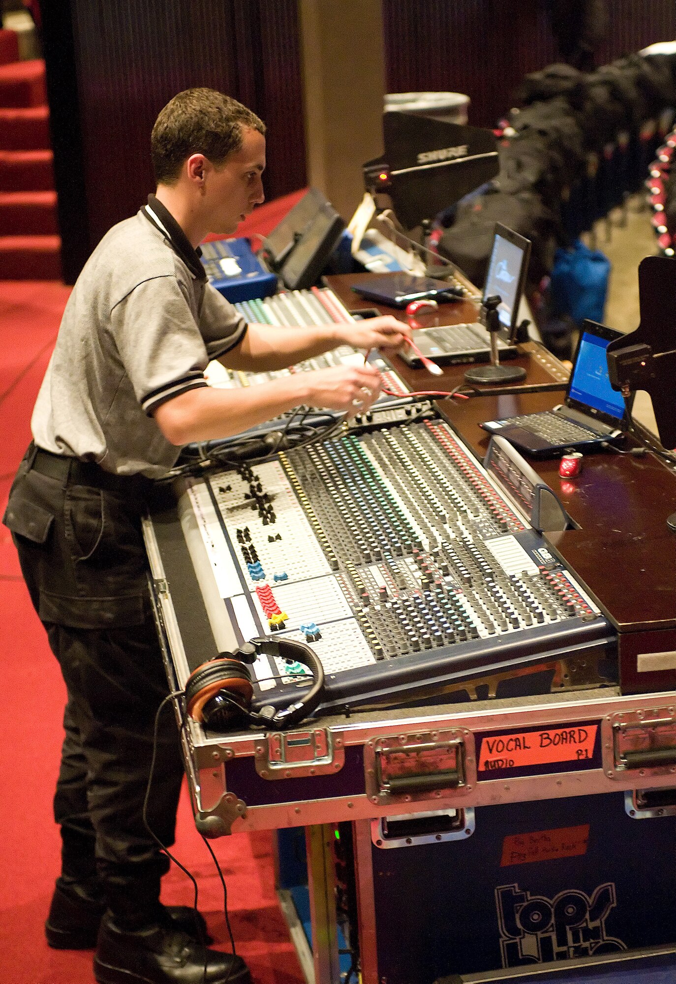 Senior Airman Aaron Elliott, Tops In Blue audio director, hooks up the sound system for the Tops In Blue performance Nov. 17 in the Delaware State University Education and Humanities Center. (U.S. Air Force photo/Brianne Zimny)