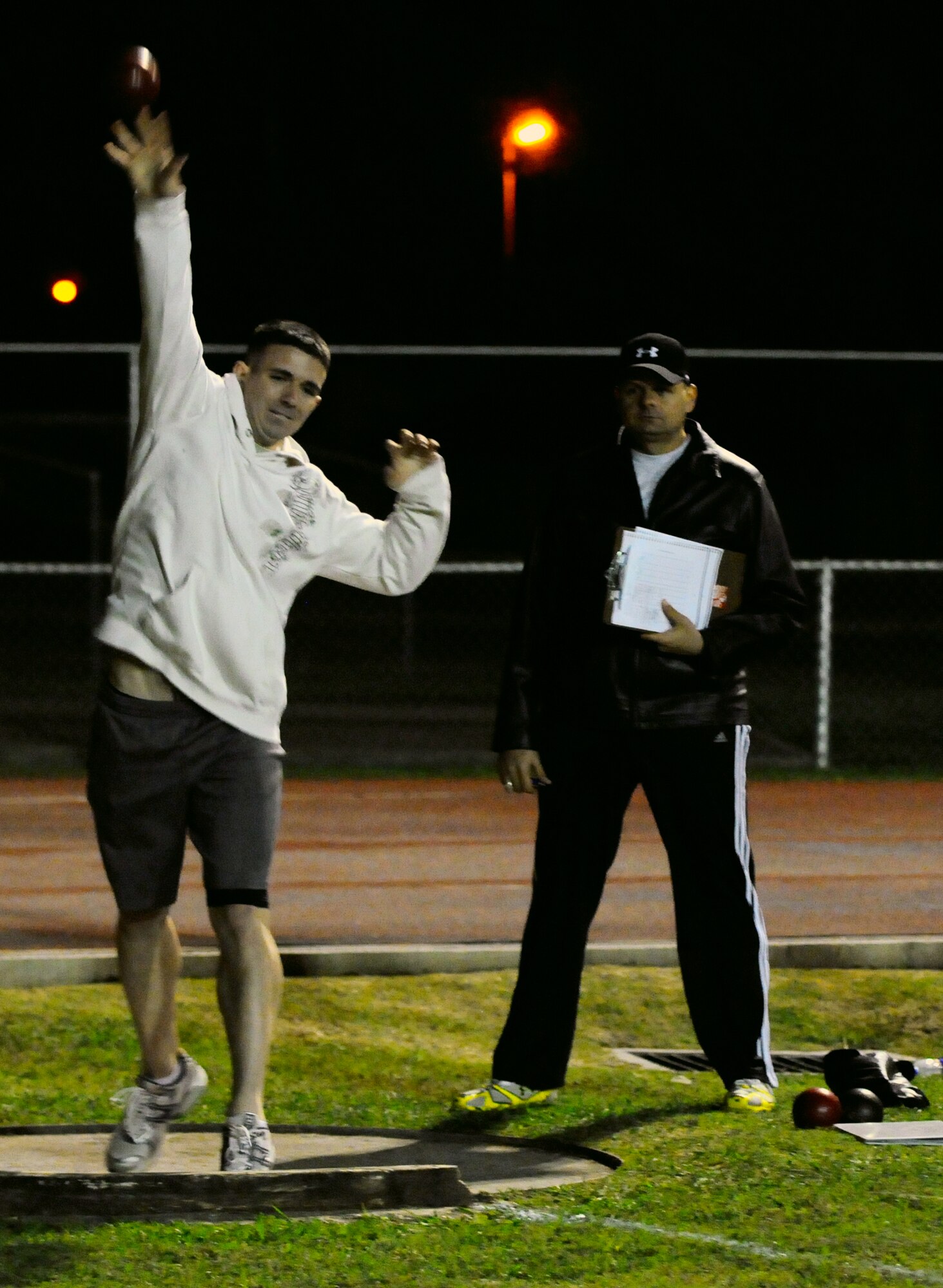 Airman 1st Ethan Cross, 39th Medical Support Squadron, throws the shot put Wednesday, Nov. 18, 2009 during the Under the Lights track competition at Incirlik’s track.  The competition pitted base units against each other in a variety of track and field events.  The 39th OS won the overall event.  (U.S. Air Force photo/Staff Sgt. Raymond Hoy)