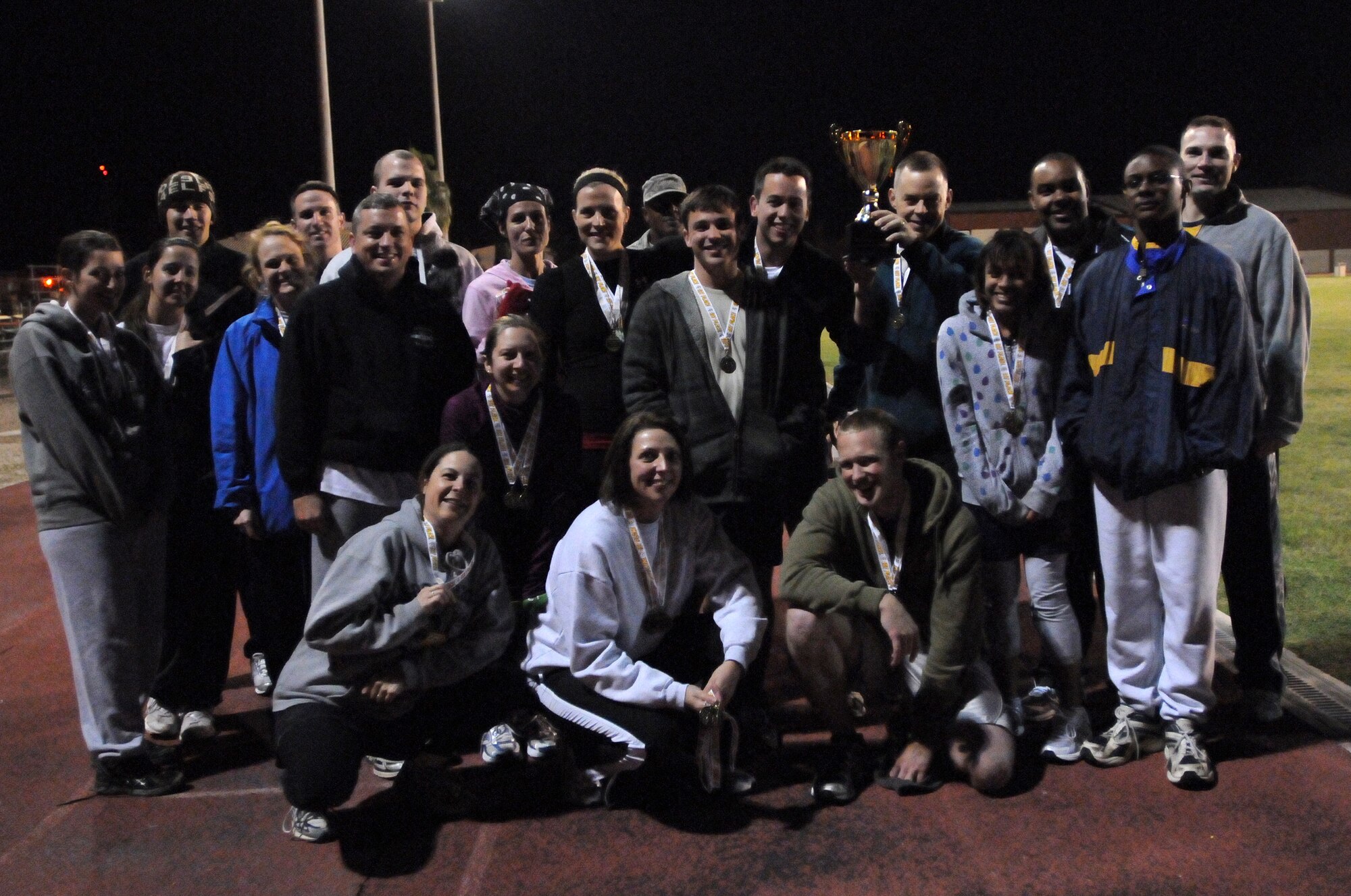 The 39th Operations Squadron poses after winning the traveling Health and Wellness Center fitness trophy during the Under the Lights track meet Wednesday, Nov.18, 2009 at the Incirlik track.  The 39th Force Support Squadron and the Health and Wellness Center hosted the competition where squadrons from around the base could compete in various events for points toward the trophy at the end of the event.  (U.S. Air Force photo/Senior Airman Ashley Wood)   