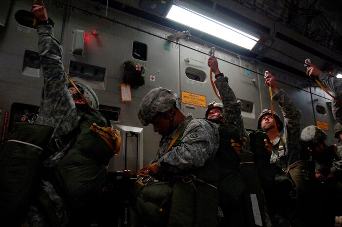 Soldiers with the 82nd Airborne Division out of Fort Bragg, N.C., hook up their static lines in preparation for an aerial jump during the Mobility Air Forces Exercise Nov. 18. More than 40 mobility aircraft and 400 soldiers from the 82 AD participated in the exercise to provide realistic training for mobility air forces and Army partners for both ongoing operations and future contingencies. (U.S. Air Force photo/Staff Sgt. Marie Brown)