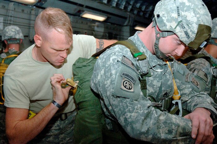 Army Sergeant William Miller, left, performs a buddy check on Army Staff Sgt. Dewey Adams, right, aboard a Charleston C-17 in preparation for an aerial jump in during the Mobility Air Forces Exercise Nov. 18. The soldiers executed a Joint Forcible Entry Airborne Assault operation during the exercise which took place at the Nevada Test and Training Range. Sergeants Miller and Adams are both with Delta Company 407, 173rd Cavalry, Fort Bragg, N.C. (U.S. Air Force photo/Staff Sgt. Marie Brown)