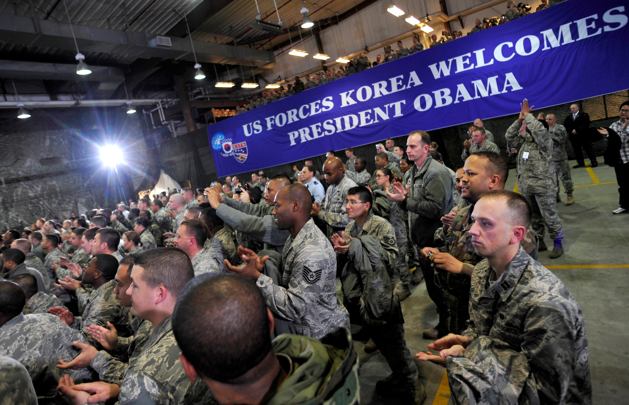 U.S. servicemembers applaud as U.S. President Barack Obama concludes his speech at Osan Air Base, Republic of Korea, Nov. 19, 2009.  This is President Obama's first visit to Korea since taking office in January.  The stop in Korea was the last leg of his Asia visit. (U.S. Air Force photo/Staff Sgt. Brian Ferguson)

