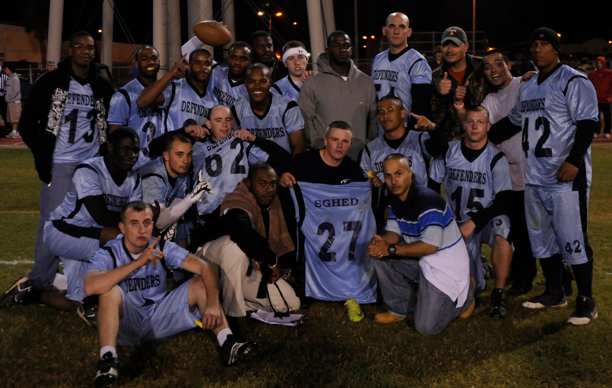 Members of the 39th Security Forces Squadron pose in celebration for winning the title of Intramural Flag Football champions after the last championship intramural flag football game at the Incirlik football field, Tuesday, Nov. 17, 2009. The 39th SFS won the first game 25 to 0 tying the 728th AMS for the intramural title. A second game was played to decide the winner of the commander’s plaque. 39th SFS won the second game 31 to 12 to secure the title. (U.S. Air Force photo/Airman 1st Class Amber Ashcraft)