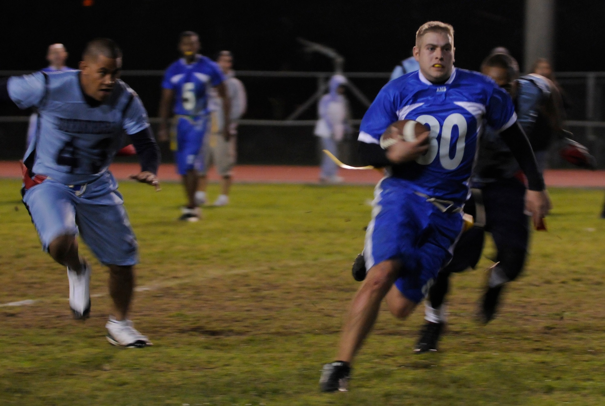 Senior Airman David Strong, 728th Air Mobility Squadron, attempts to avoid members of the 39th Security Forces Squadron during the second championship intramural flag football game at the Incirlik football field, Tuesday, Nov. 17, 2009. The 39th SFS won the first game 25 to 0 tying the 728th AMS for the intramural title. A second game was played to decide the winner of the commander’s plaque. 39th SFS won the second game 31 to 12 to secure the title.  (U.S. Air Force photo/Airman 1st Class Amber Ashcraft)