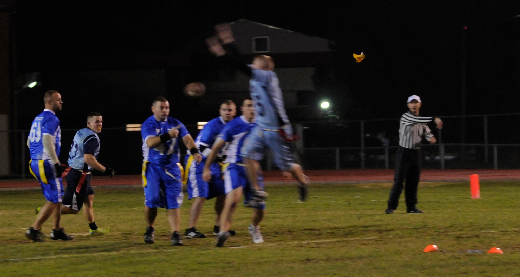 The head referee throws a flag on a play during the championship intramural flag football game at the Incirlik football field, Tuesday, Nov. 17, 2009. The 39th SFS won the first game 25 to 0 tying the 728th AMS for the intramural title. A second game was played to decide the winner of the commander’s plaque. 39th SFS won the second game 31 to 12 to secure the title. (U.S. Air Force photo/Airman 1st Class Amber Ashcraft)