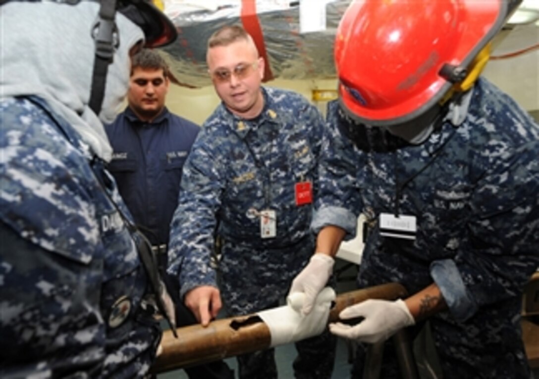U.S. Navy Chief Petty Officer John M. Kaczor gives instruction on proper pipe-patching procedures during a general quarters drill aboard the aircraft carrier USS Enterprise (CVN 65) in Newport News, Va., on Nov. 10, 2009.  