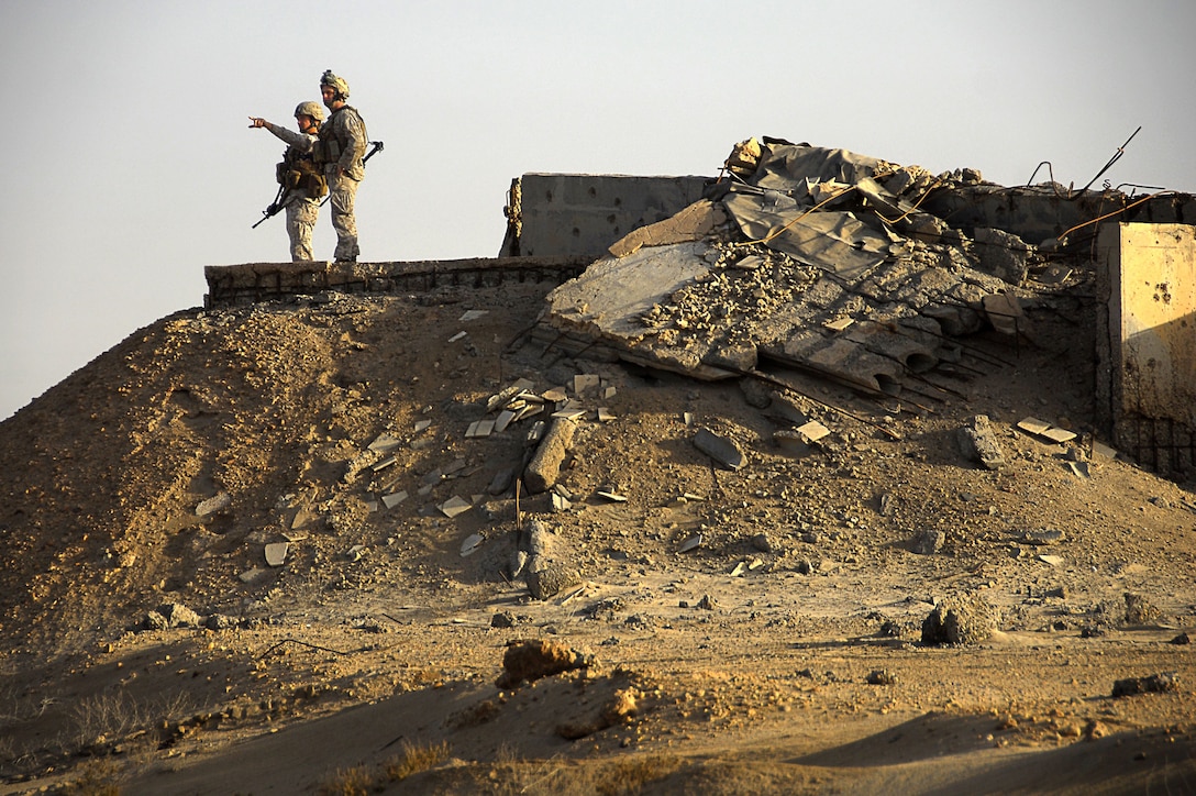 Eleventh Marine Expeditionary Unit Marines survey this uninhabited island Nov. 20 where a Navy and Marine Corps team practiced an amphibious landing from ships in the Persian Gulf and the MEU’s reconnaissance Marines trained with Kuwaiti commandos.