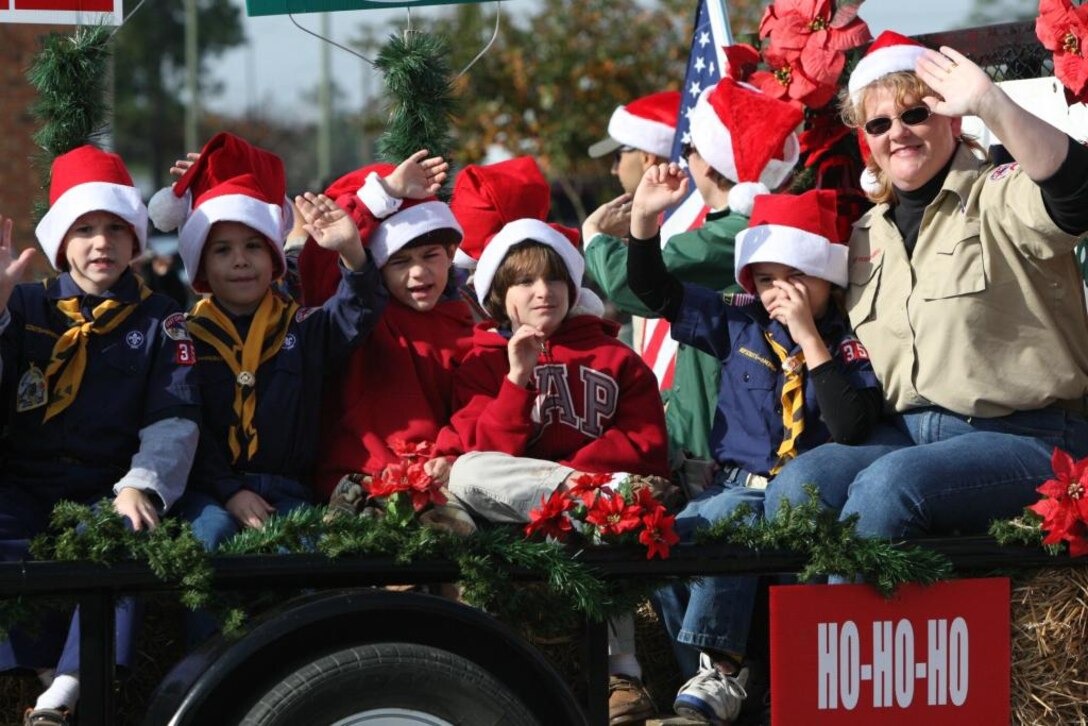 Jacksonville boy scout troop 357 waves at the crowds duruing the holiday parade on Western Boulevard in Jacksonville, N.C., Nov. 17.