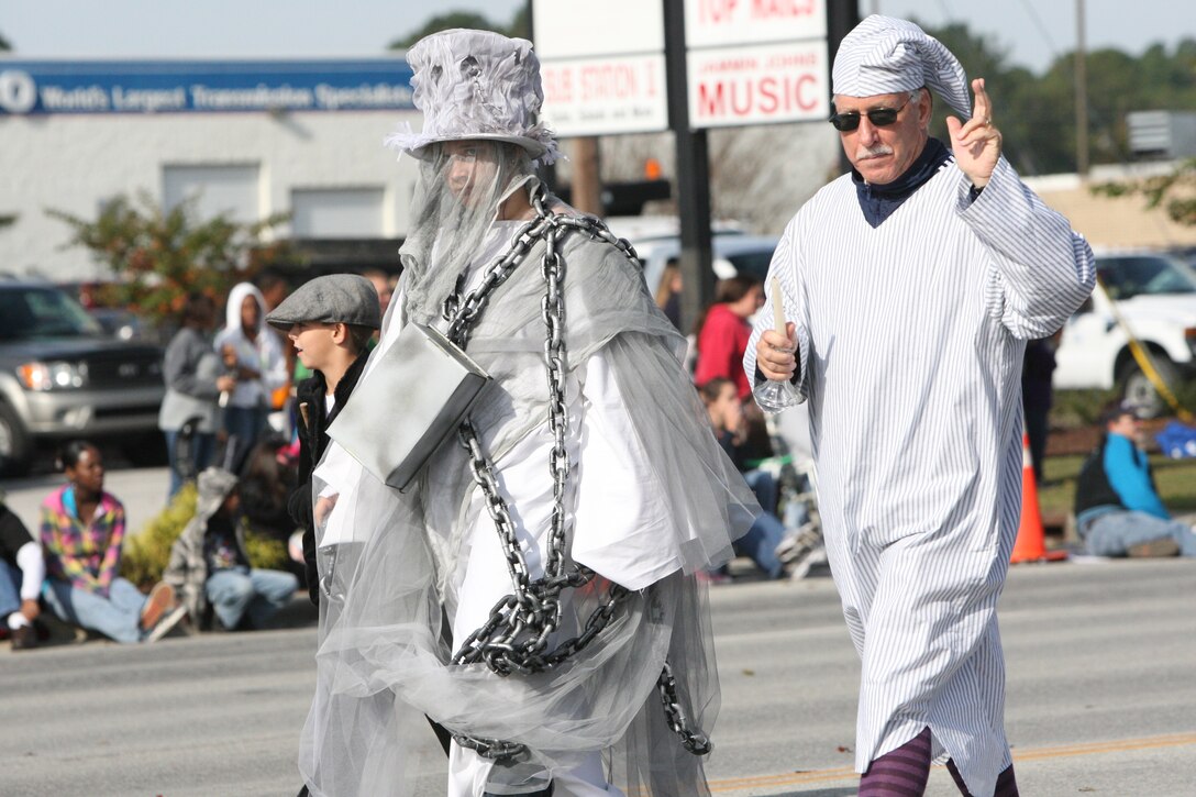 Ghosts of Christmans past and present from Coldwell Banker SeaCoast Realty walk in the Holiday Parade of Jacksonville, N.C., Nov. 17.