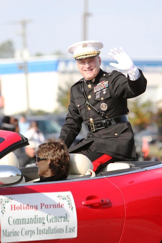 Maj. Gen. Carl B. Jensen, commanding general of Marine Corps Installations-East, waves at the crowds with a smile during the Holiday Parade in Jacksonville, N.C., Nov. 17.