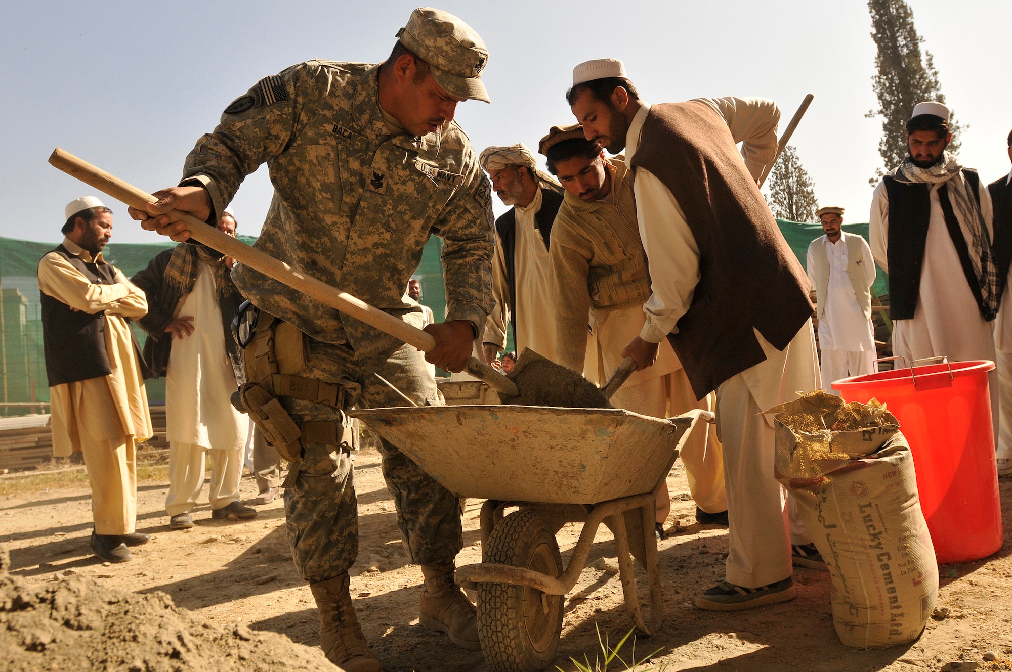 KHOST PROVINCE, Afghanistan -  U.S. Navy Builder 1st Class Iascc Baca, Khost Provincial Reconstruction Team engineer, teaches proper mortar mixing technique to local engineers, construction contractors, and foremen during a monthly contractor training session held at the Civil Military Operations Center, Khost, Afghanistan recently. Engineers from the Khost PRT provided construction quality assurance training to locals in order to facilitate high quality construction practices in the region.(U.S. Air Force photo/Staff Sgt. Stephen J. Otero)