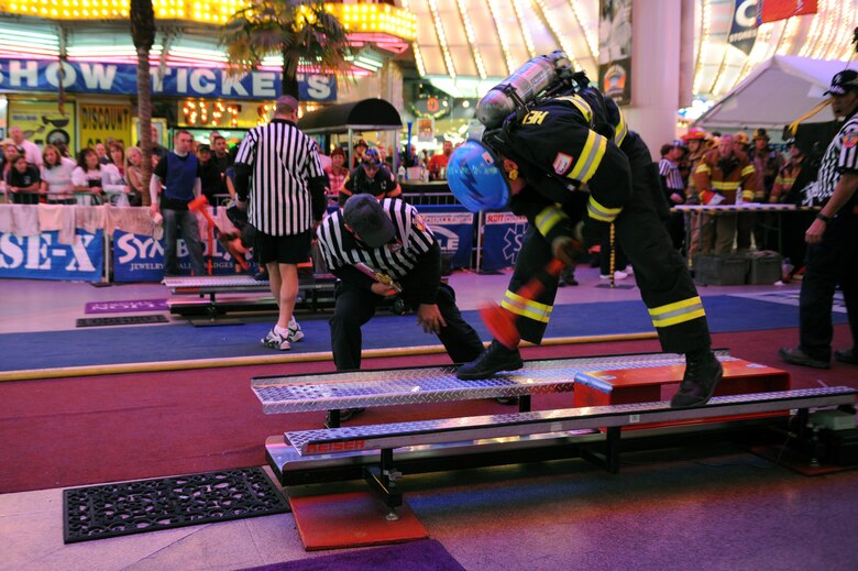 Ken Helgerson uses a sledgehammer to a sled assimilating cutting open a roof as he competes in the team relay event Nov. 20, 2009, at the Scott Firefighter Combat Challenge in Las Vegas. Mr. Helgerson is a firefighter at the Air Force Academy in Colorado Springs, Colo. (U.S. Air Force photo/Staff Sgt. Desiree N. Palacios)