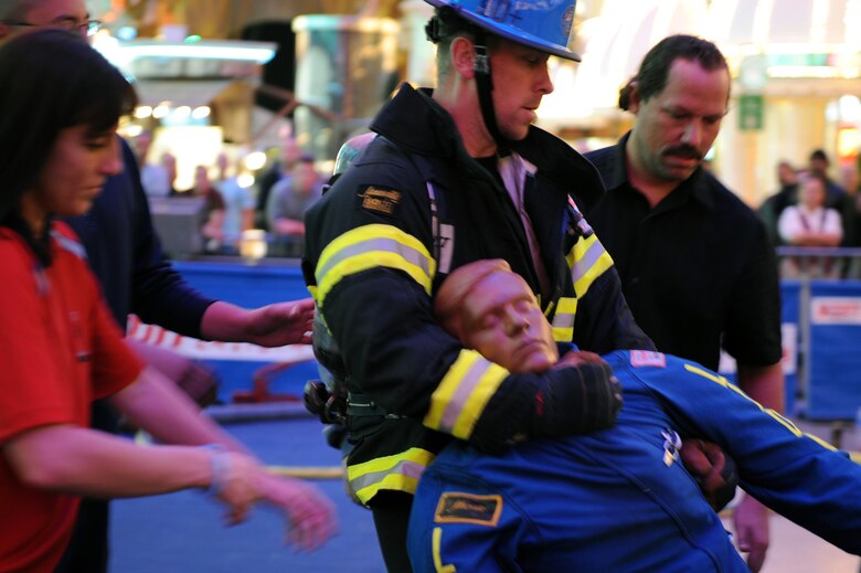 Ken Helgerson "rescues" a life-sized 175-pound "victim” as he competes in the team relay event Nov. 20, 2009, at the Scott Firefighter Combat Challenge in Las Vegas. Mr. Helgerson is a firefighter at the Air Force Academy in Colorado Springs, Colo. (U.S. Air Force photo/Staff Sgt. Desiree N. Palacios)