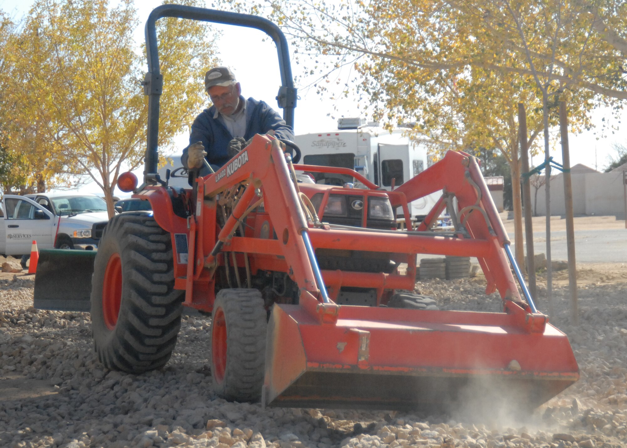 David Troescher, Committee to Honor California Veterans chairman, spreads rocks around the courtyard of Edwards Family Camp as part of a 95th Force Support Squadron beautification effort Nov. 20. (Air Force photo/Airman 1st Class William O'Brien)