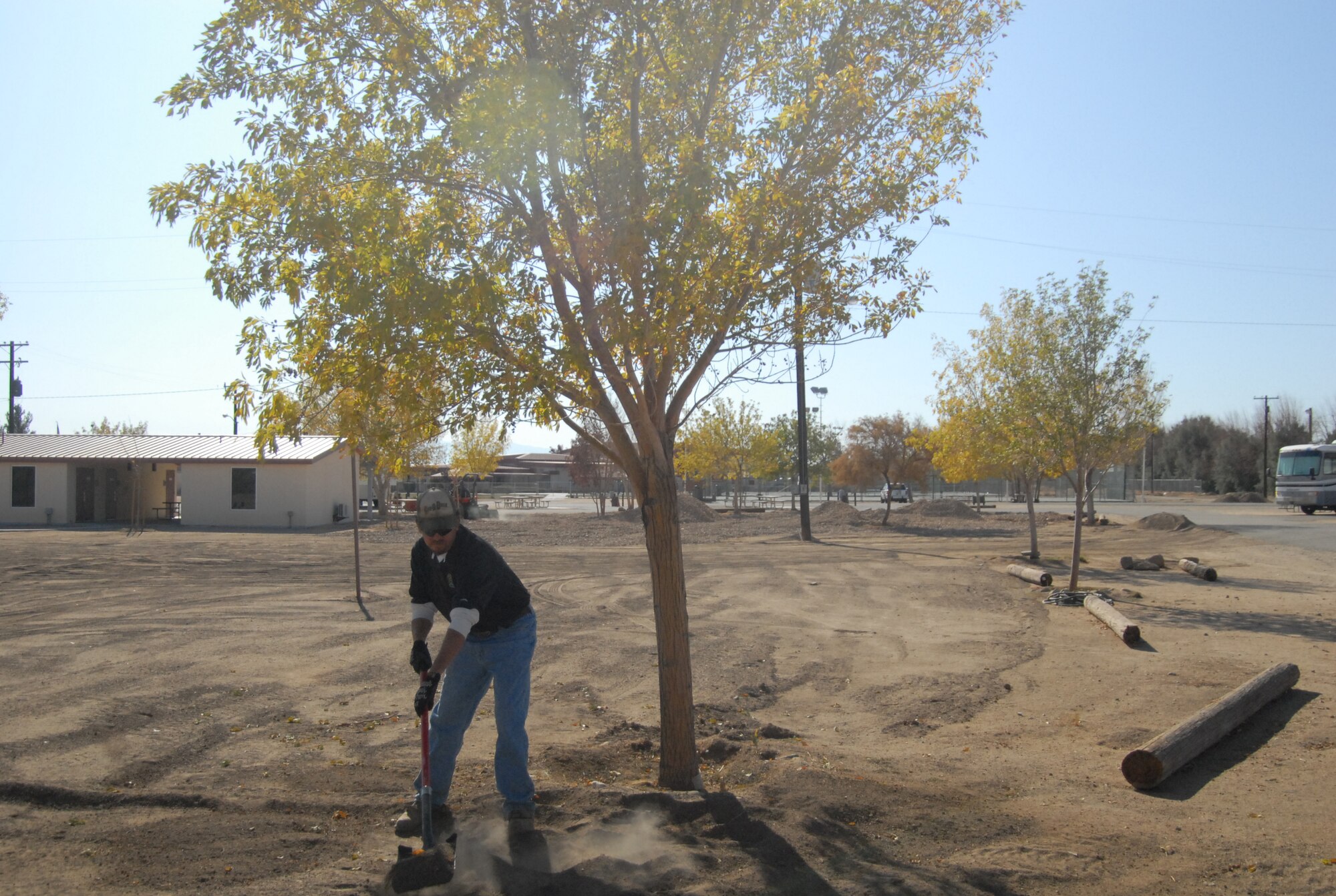 Danny Stephens, 95th Force Support Squadron Outdoor Recreation laborer levels the soil at Edwards Fam Camp courtyard so rocks can be put down level Nov. 20. The 95th Force Support Squadron decided on this beautification effort based off feedback they received. (Air Force photo/Airman 1st Class William O'Brien)
