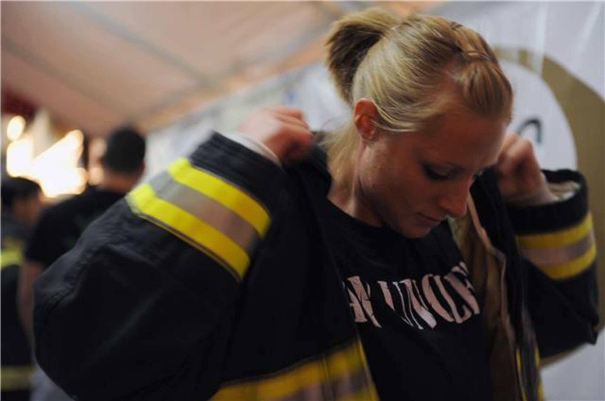 Staff Sgt. Jessica Packard puts on her full bunker gear, including an air-breathing apparatus, before she competes in the individual relay event Nov. 19, 2009, at the Scott Firefighter Combat Challenge in Las Vegas. Sergeant Packard took 3rd place overall in the female individual competition.  She is stationed at Goodfellow Air Force Base, Texas. (U.S. Air Force photo/Staff Sgt. Desiree N. Palacios)