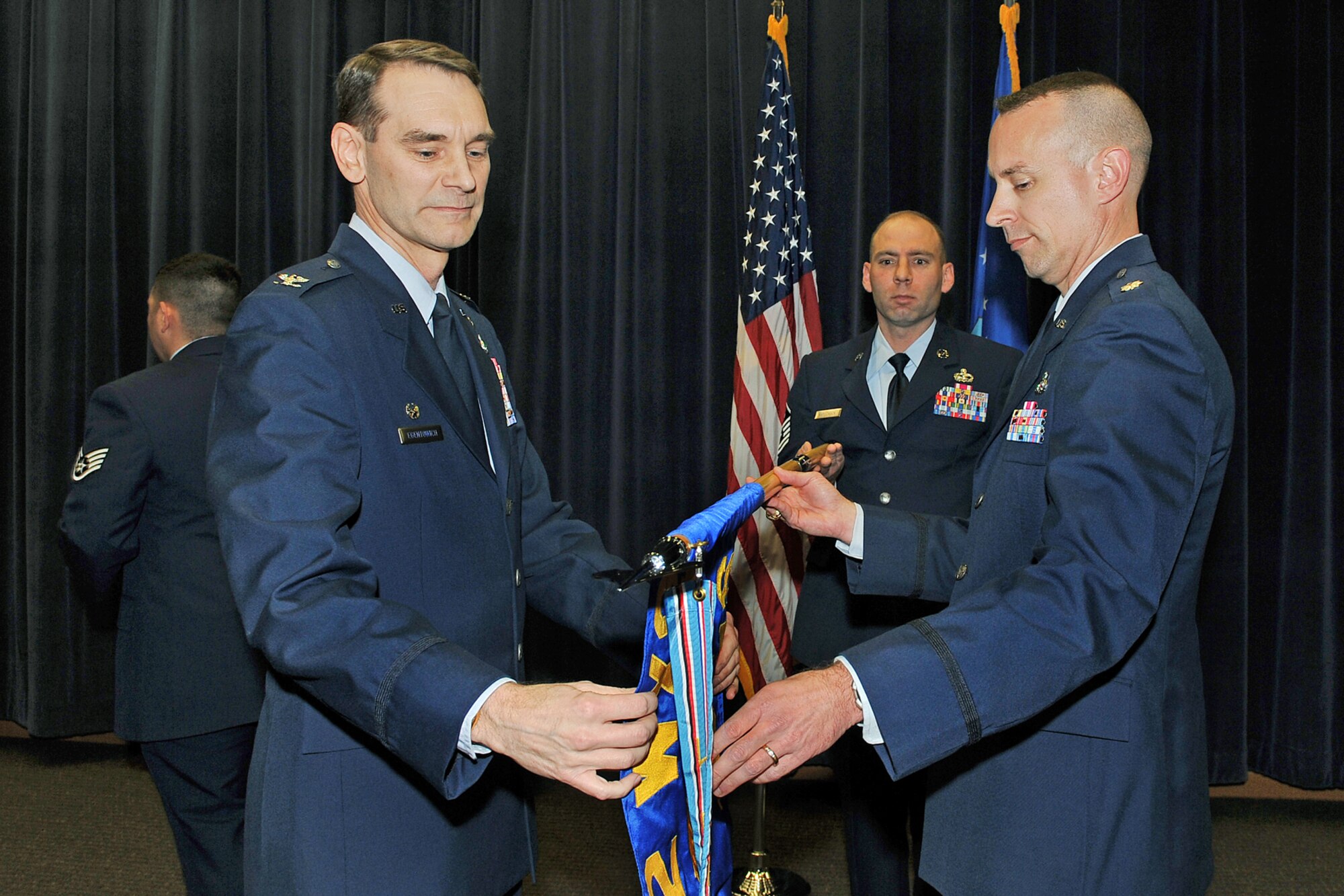 OFFUTT AIR FORCE BASE, Neb. ? Col.l John M. Egentowich, 2nd Weather Group commander and Maj. Neil T. Sanger, unfurl the 16th Weather Squadron's guideon during the unit?s reactivation ceremony at the Air Force Weather Agency auditorium here Nov.18.  In July of 1959, the 16th WS was reactivated at Ft. Monroe, Va. and assigned to the 2nd WXG. Operations continued until the squadron was deactivated in October 1976. After 33 years, the 16th WS was reactivated at Offutt and for the second time assigned to the 2nd WXG. U.S. Air Force photo by Charles Haymond
