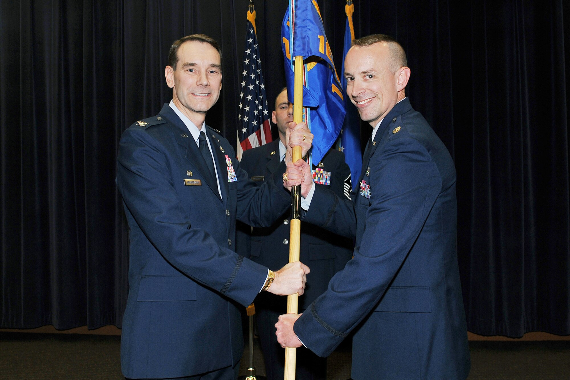 OFFUTT AIR FORCE BASE, Neb. ? Col. John M. Egentowich, 2nd Weather Group commander, passes the 16th Weather Squadron guideon to Maj. Neil T. Sanger, as he assumes command of the 16th WS during a ceremony at the Air Force Weather Agency auditorium here Nov. 18. In July of 1959, the 16th WS was reactivated at Ft. Monroe, Va. and assigned to the 2nd WXG. Operations continued until the squadron was deactivated in October 1976. After 33 years, the 16th WS was reactivated at Offutt and for the second time assigned to the 2nd WXG. U.S. Air Force photo by Charles Haymond
[CLEARED: Deborah Aragon]
