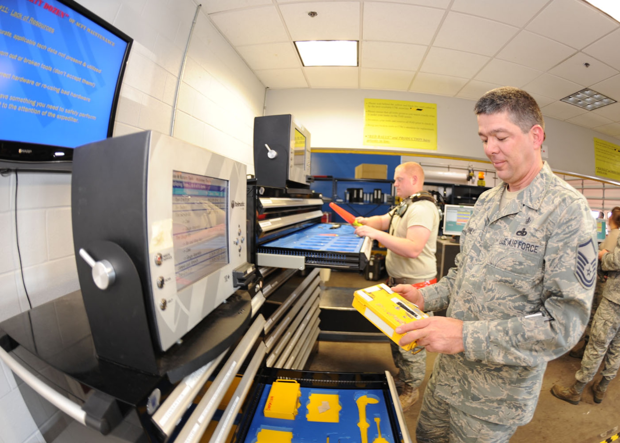 DYESS AIR FORCE BASE, Texas – Senior Airman William Faith, 317 Aircraft Maintenance Squadron Hydraulics, and Master Sgt. Doyle McKinney, 317 Aircraft Maintenance Squadron Support flight chief, sign out tools from the new electronic toolboxes here Nov. 19. The new electronic toolboxes were first introduced 3 years ago and are designed for specialty tools. Airmen will sign out tools by swiping their Common Access Card, which will help prevent the loss of tools and reduce FOD. Dyess purchased 11 new toolboxes since 2008 and plans to purchase 14 more in the future. These toolboxes save 25 man-hours a day, and $35 per man-hour per toolbox. (U.S. Air Force photo by Senior Airman Jennifer Romig)