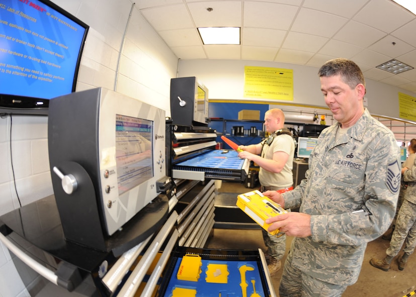 DYESS AIR FORCE BASE, Texas – Senior Airman William Faith, 317 Aircraft Maintenance Squadron Hydraulics, and Master Sgt. Doyle McKinney, 317 Aircraft Maintenance Squadron Support flight chief, sign out tools from the new electronic toolboxes here Nov. 19. The new electronic toolboxes were first introduced 3 years ago and are designed for specialty tools. Airmen will sign out tools by swiping their Common Access Card, which will help prevent the loss of tools and reduce FOD. Dyess purchased 11 new toolboxes since 2008 and plans to purchase 14 more in the future. These toolboxes save 25 man-hours a day, and $35 per man-hour per toolbox. (U.S. Air Force photo by Senior Airman Jennifer Romig)