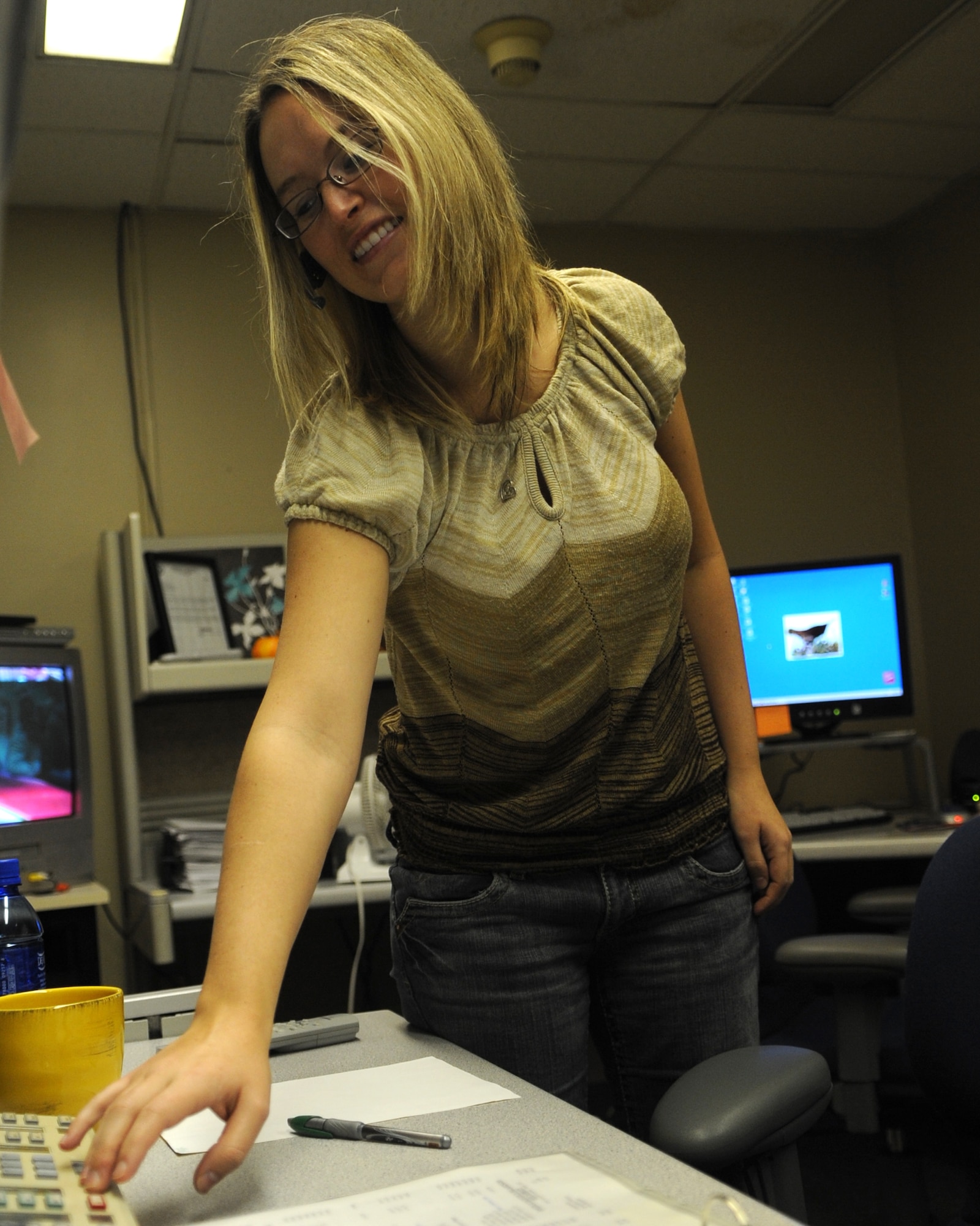 WHITEMAN AIR FORCE BASE, Mo. – Amy Jenkins, a base operator, responds to an incoming call, Nov. 20. The base operators direct hundreds of calls each day for Whiteman Air Force Base. (U.S. Air Force photo/ Senior Airman Cory Todd) (Released)
