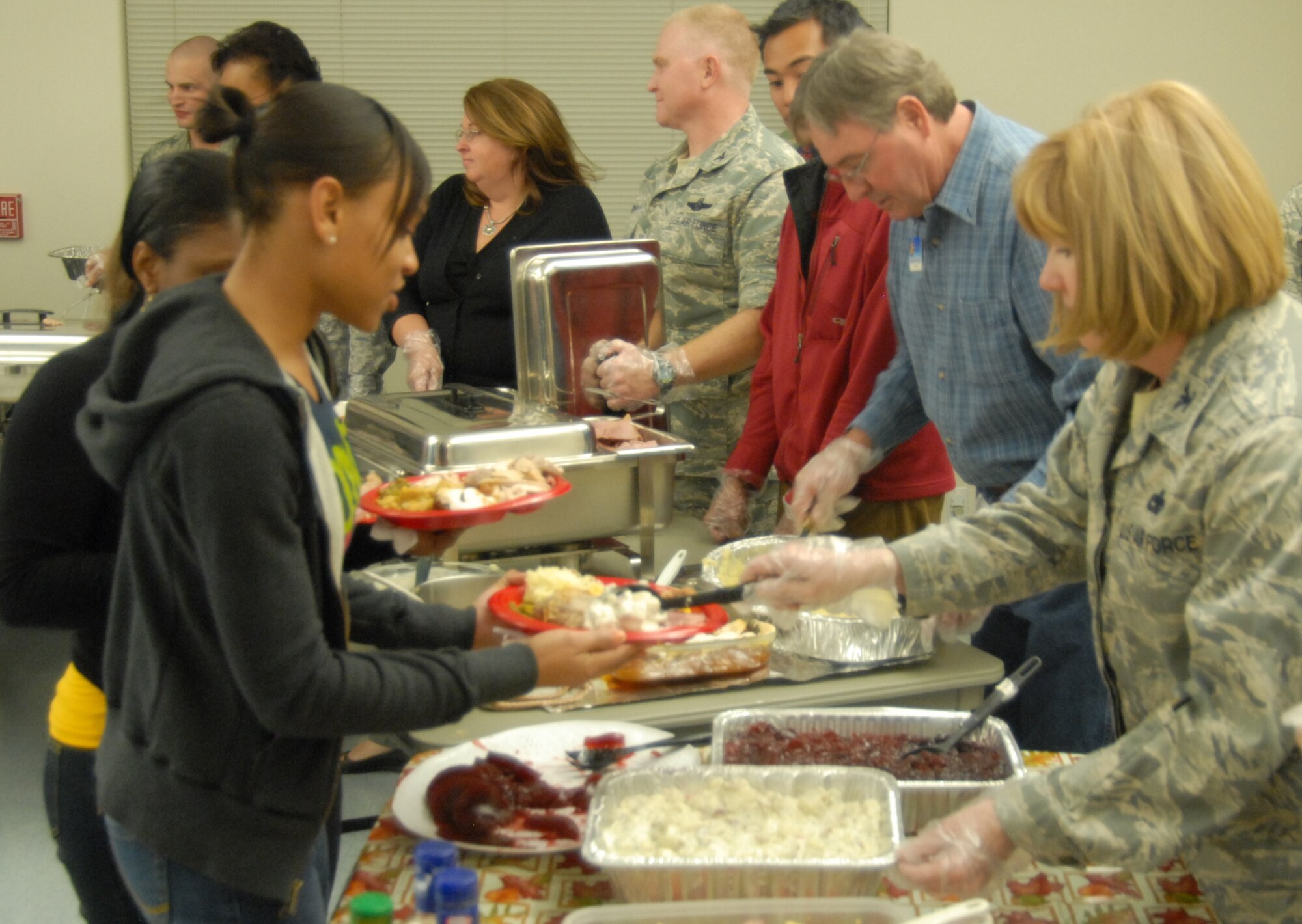 Senior Airman Bernice Edward, 95th Medical Operations Squadron life skills receptionist, gets food from Col. Mary Ann Behne, 412th Maintenance Group commander, during the Dorm DwellersThanksgiving Dinner at the Chapel 1 Annex Nov. 19. The dinner was held so that Airmen and Marines who live in the dorms could receive a Thanksgiving dinner. (Air Force photo/Airman 1st Class William O'Brien)