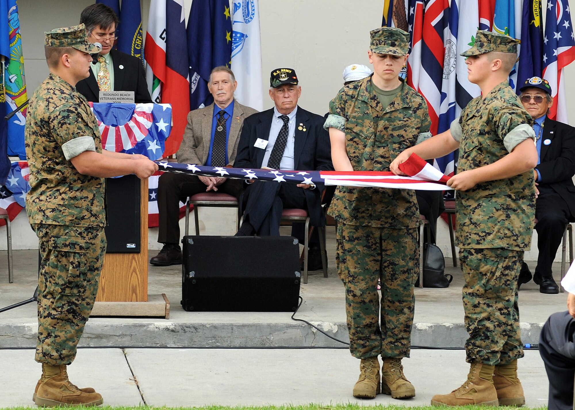 Members of the Redondo Union High School Marine Corps Junior ROTC fold the flag, which was presented to VFW Post 2828 during the 7th annual Veterans Day Tribute held by the City of Redondo Beach, Calif., Nov. 11. The event honored the veterans and current military personnel of all United States wars. (Photo by Joe Juarez)
