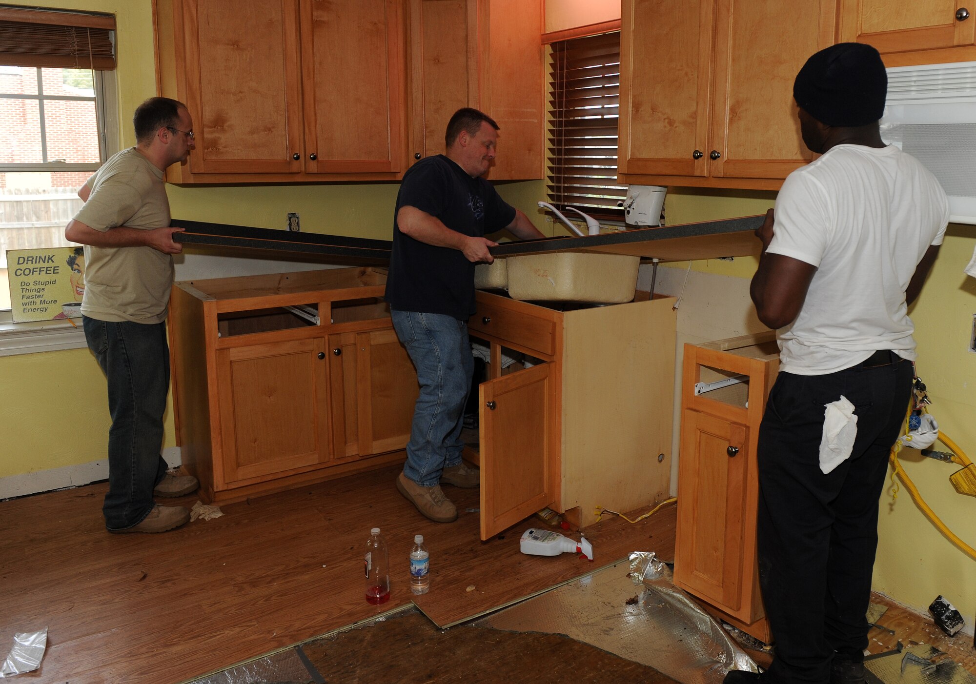 LANGLEY AIR FORCE BASE, Va. -- Senior Airman Brian Norman and Tech. Sgt.
Duane Smith, 15th Intelligence Squadron personnel, help Nathanael Cherry,
homeowner, move a countertop in his Hampton home Nov. 19.  Langley Airmen
spent several hours performing post-storm cleanup for those impacted in the
local community. (U.S. Air Force photo/Senior Airman Zachary Wolf)
