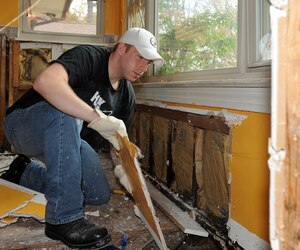 LANGLEY AIR FORCE BASE, Va. -- Senior Airman Zach Vaughn, Air Combat Command Public Affairs broadcaster, rips out a section of wall damaged by flood water in a Hampton home Nov. 19.  Langley Airmen spent several hours
performing post-storm cleanup for those impacted in the local community. (U.S. Air Force photo/Senior Airman Zachary Wolf)
