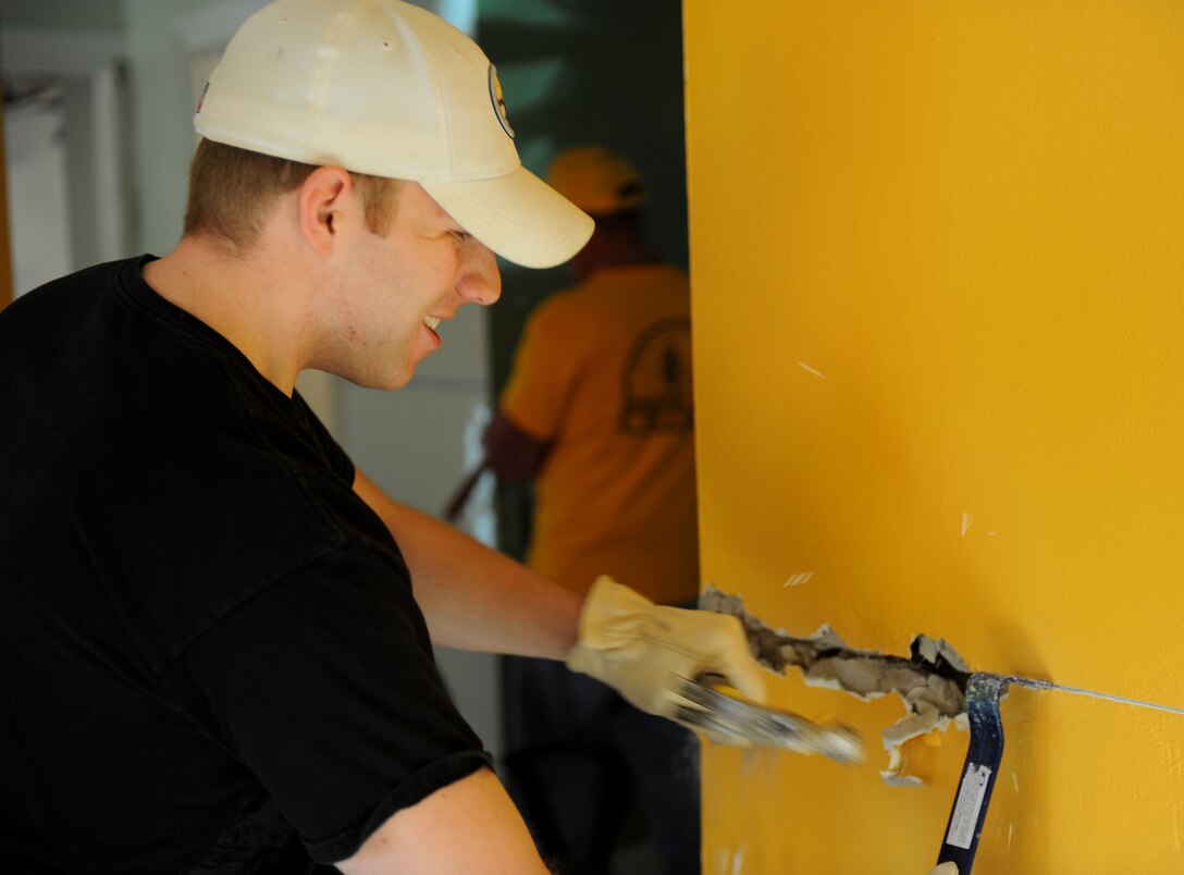 LANGLEY AIR FORCE BASE, Va. --  Senior Airman Zach Vaughn, Air Combat
Command Public Affairs broadcaster, knocks out a wall Nov. 19 in a Hampton
home damaged by the recent nor'easter.  Langley Airmen spent several hours
performing post-storm cleanup for those impacted in the local community.
(U.S. Air Force photo/Senior Airman Zachary Wolf) 

