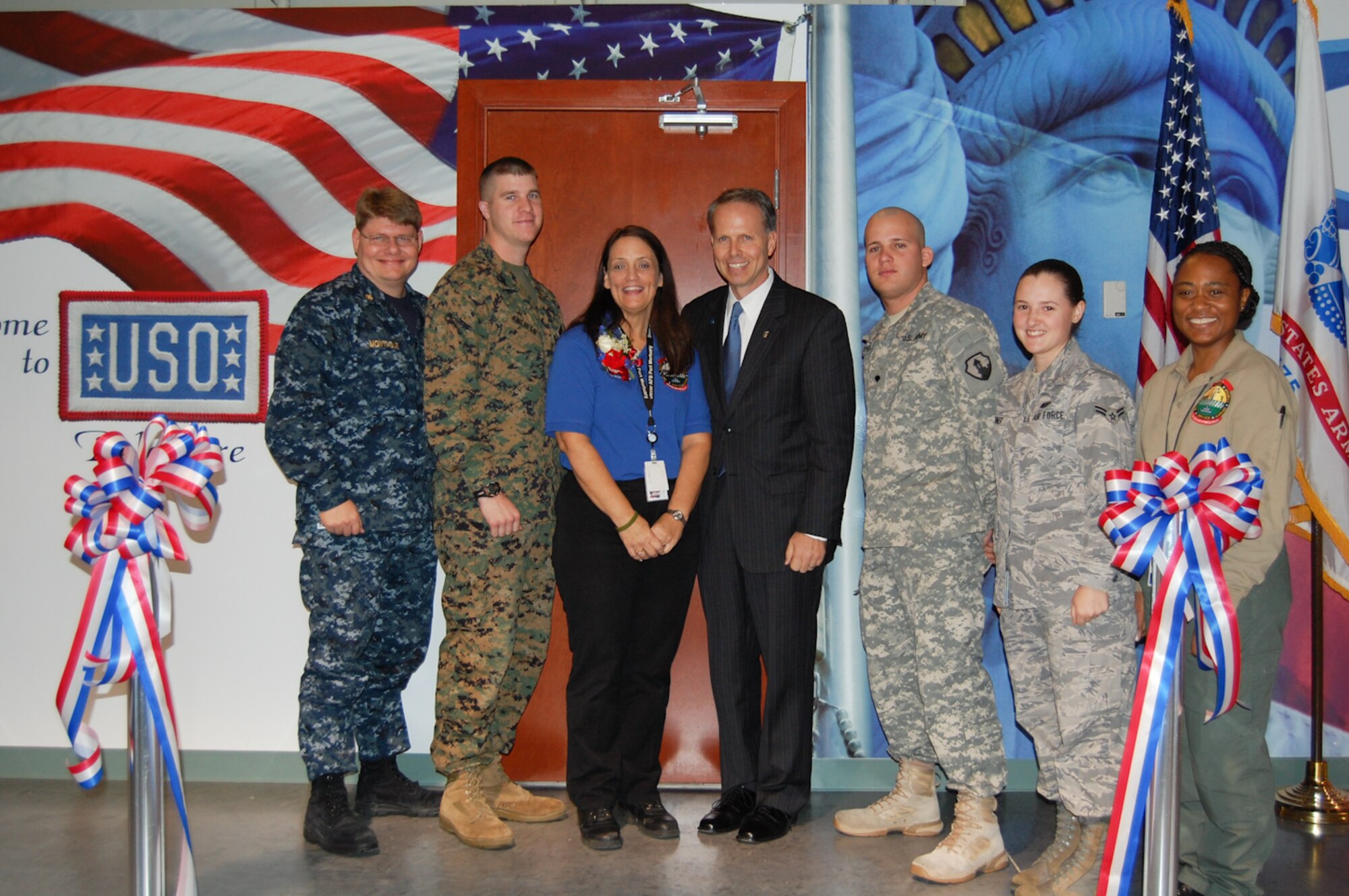 Mr. Charles Milam (right center), director of Air Force Services and Ms. Joan Cote (left center), director of the Delaware USO, cut the ribbon for the new break room at the Air Force Mortuary Affairs Operations Center on Nov. 13, 2009. Military members from all branches assigned to work at AFMAO also took part in helping open the new 1,600 sq. ft. 