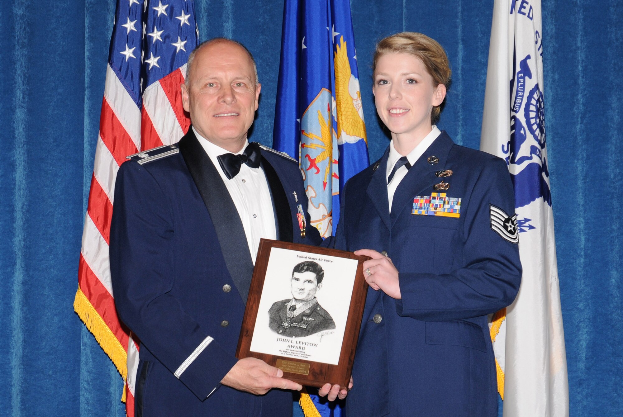 McGHEE TYSON AIR NATIONAL GUARD BASE, Tenn. -- Tech. Sgt. Rebekah L. Birt, right, a personnelist with the 125th Special Tactics Squadron, Oregon Air National Guard, receives the John L. Levitow Honor Award for NCO Academy Class 10-1 from Lt. Col. Stan Giles, left, at The I.G. Brown Air National Guard Training and Education Center here, Nov. 19, 2009.  The John L. Levitow Award is the highest honor awarded a graduate of any Air Force enlisted professional military education course.  (U.S. Air Force photo by Master Sgt. Kurt Skoglund/Released)