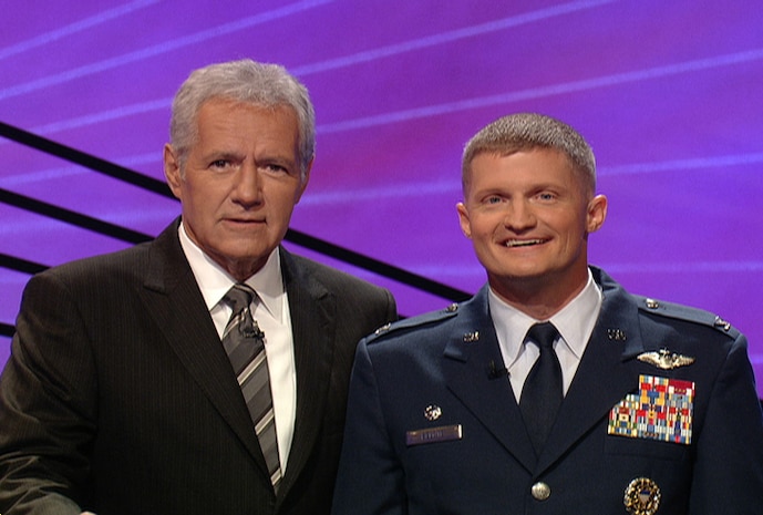 LOS ANGELES-- Col. Dave Belote, 99th Air Base Wing commander, poses for a photo with Alex Trebek, the host of “Jeopardy!”, while participating on an episode of the show which is due to air Dec. 2.(Photo by "Jeopardy!" Productions, Inc.)