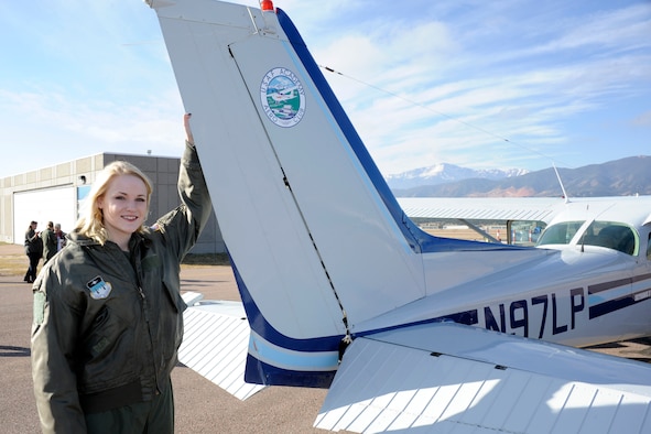 Hannah Marklin, 16, Academy's newest cadet for a day, poses at the tail of a Cessna during her visit to the Academy. Her weekend kicked off with a tour of the 98th Flying Training Squadron and a hanging harness training demo in its indoor training facility followed by an acrobatic glider demonstration and tour of the air traffic contol tower. 