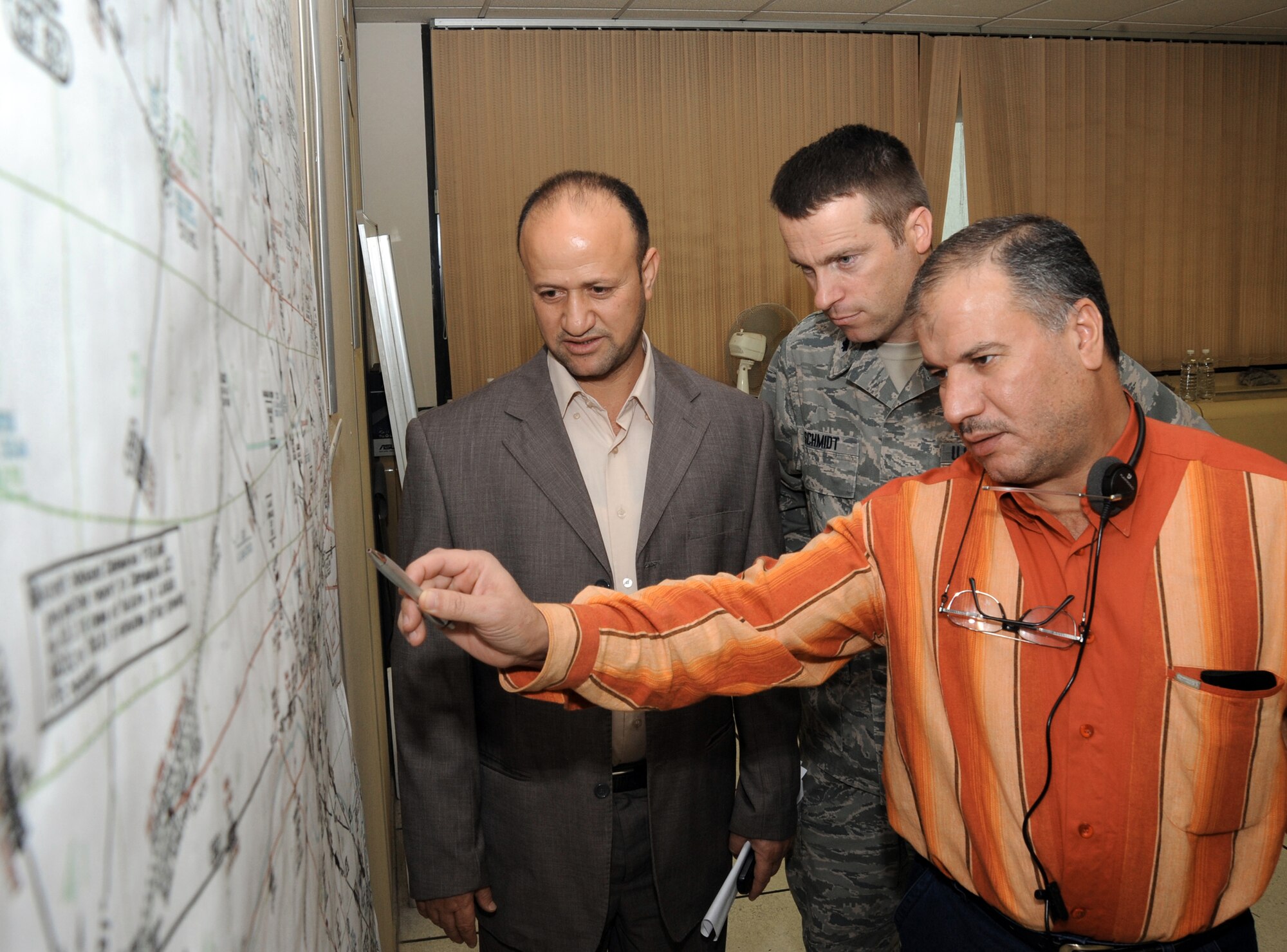 Lt. Col. Tom Schmidt observes while Iraq Civil Aviation Authority members discuss the new Iraqi airway structure Nov. 18, 2009. Colonel Schmidt spent the past seven months helping the Iraqis develop new air routes. These routes will increase efficiency and capacity through Iraqi airspace, normalizing Iraq's airspace and increasing its air traffic growth. Colonel Schmidt is the Air Component Coordination Element airspace planner. (U.S. Air Force photo/Tech. Sgt. Johnny L. Saldivar)
