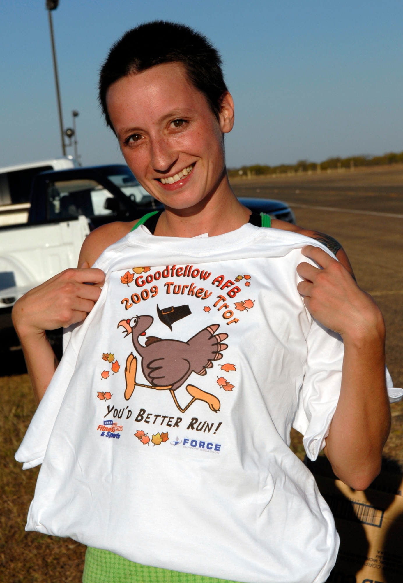GOODFELLOW AIR FORCE BASE, Texas -- Navy Petty Officer 2nd Class Julie Cheney models the Goodfellow AFB 2009 Turkey Trot t-shirt, Nov. 18. Petty Officer Cheney is a student with the Navy Center for Information Dominance Detachment and placed second in the women's category with a time of 15 minutes, 50 seconds. (U.S. Air Force photo/Lou Czarnecki)