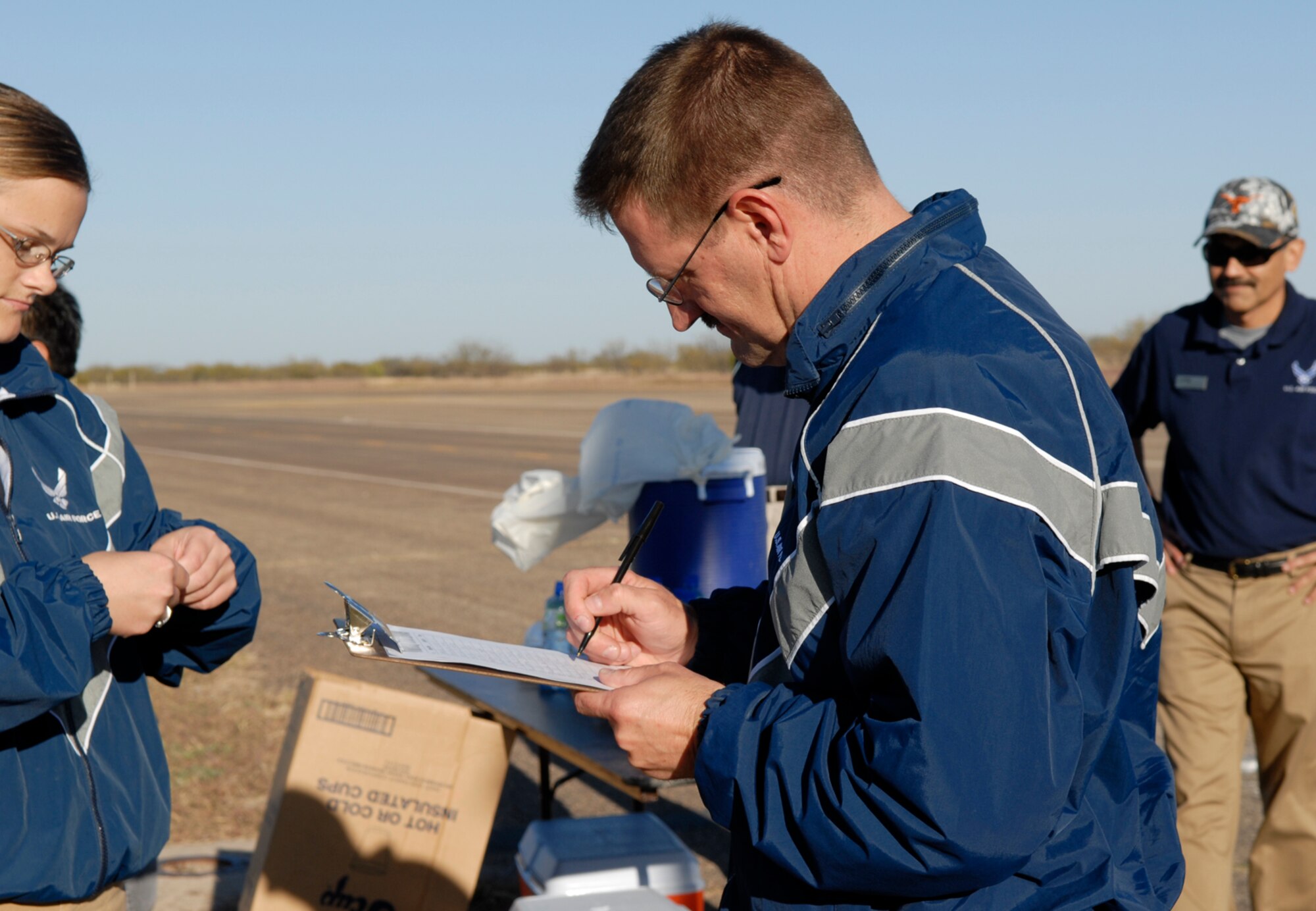 GOODFELLOW AIR FORCE BASE, Texas -- Master Sgt. John Teutsch, 17th Medical Group, signs up for a place in the Goodfellow AFB 2009 Turkey Trot, Nov. 18. The 5 kilometer event took place at the "triangle" on the old flightline. (U.S. Air Force photo/Lou Czarnecki)