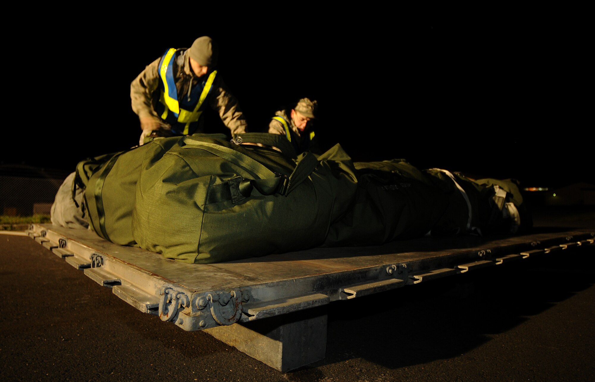 SPANGDAHLEM AIR BASE, Germany -- Airman Keith Miller, 52nd Security Forces Squadron, and Airman 1st Class George Torres, 52nd Mission Support Group, build a pallet of personal mobility bags outside Bldg. 103 Nov. 19. The 52nd Fighter Wing evaluated its ability to prepare for a real world rapid deployment of personnel and assets to a forward-operating base during Operation Saber Crown 10-02. (U.S. Air Force photo/Airman 1st Class Nathanael Callon)
