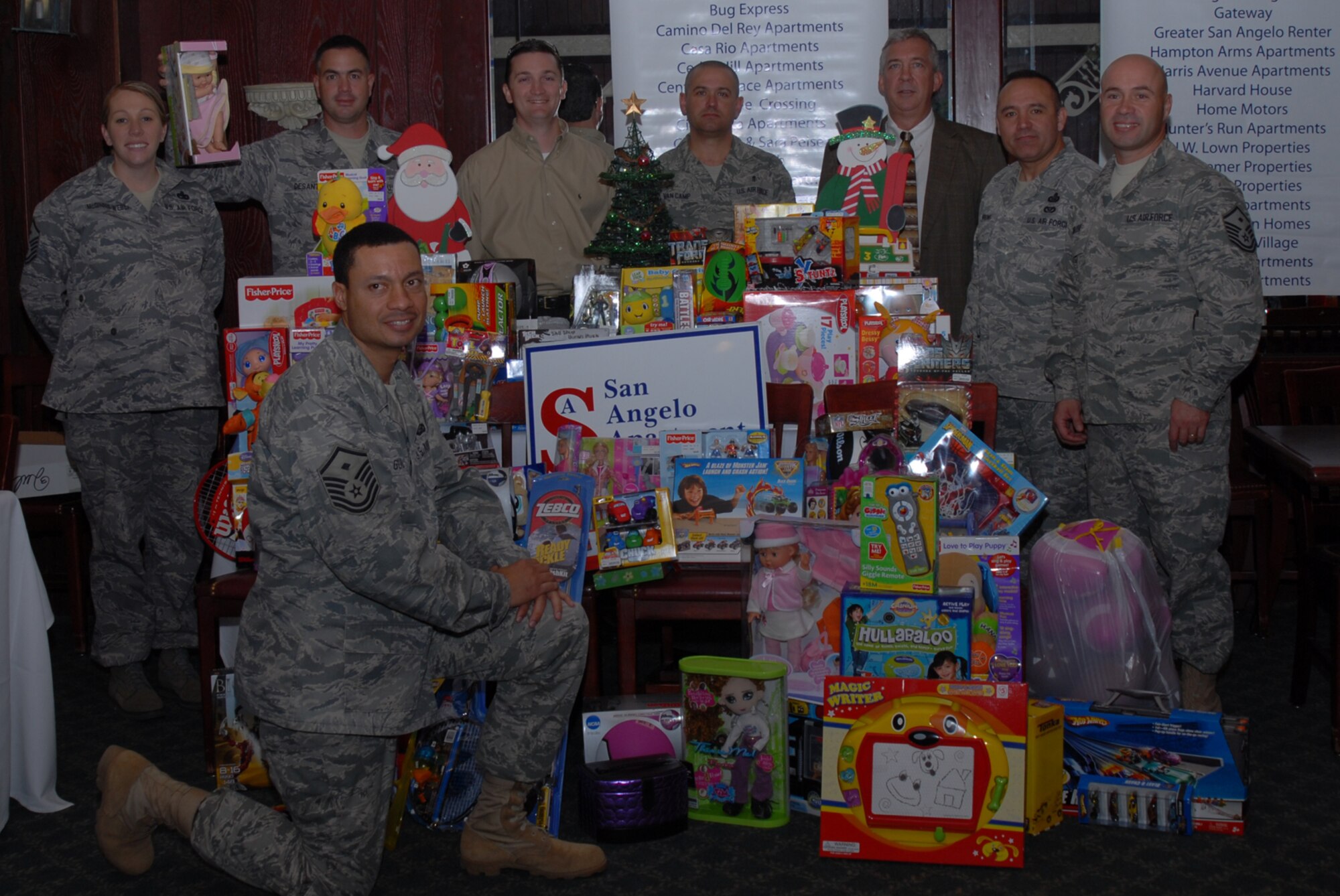 SAN ANGELO, Texas -- Goodfellow Air Force Base 1st Sgts. joined by Scott Tankersley and Michael Noret gather around toys donated by the San Angelo Apartment Association for Operation Warmheart, Nov. 18, 2009. Operation Warmheart is a year-round program to assist servicemembers and their families by providing food, clothes, toys, and in some cases funds for those in need. The program is managed by the First Sergeants Council and supported by volunteers from the base and community. Mr. Tankersley is President, San Angelo Apartment Association and Mr. Noret is Deputy Director, 17th Civil Engineer Squadron. (U.S. Air Force photo/Staff Sgt. Laura R. McFarlane)